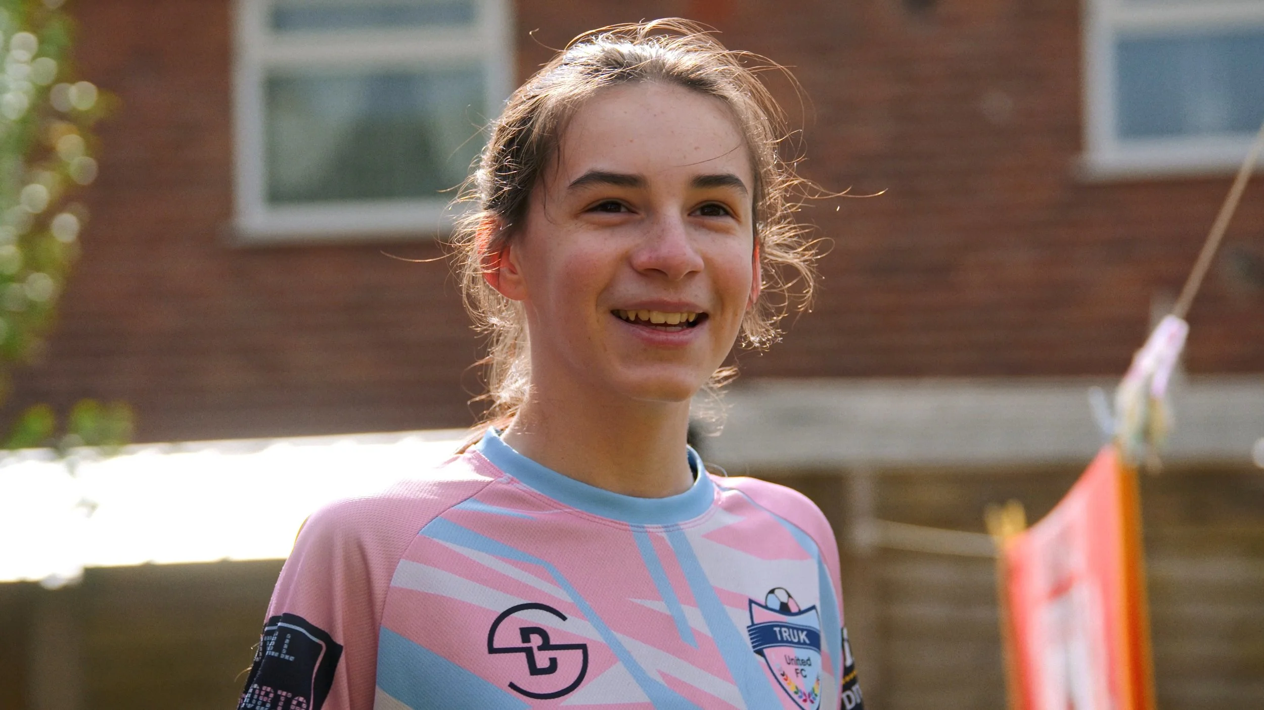 Emily smiles as the sun hits her face