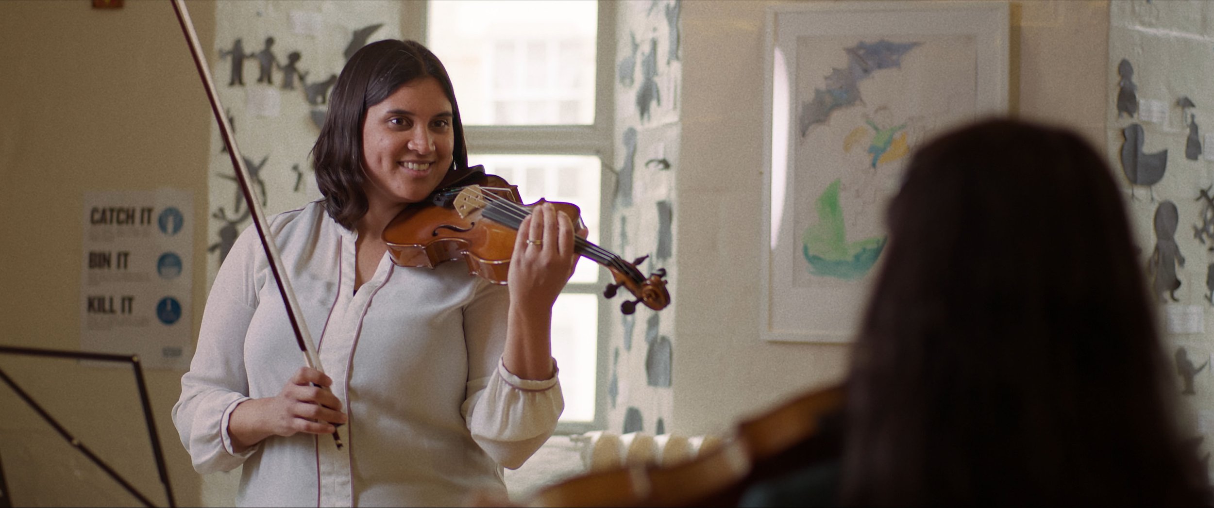 Zara and her teacher practice a piece together