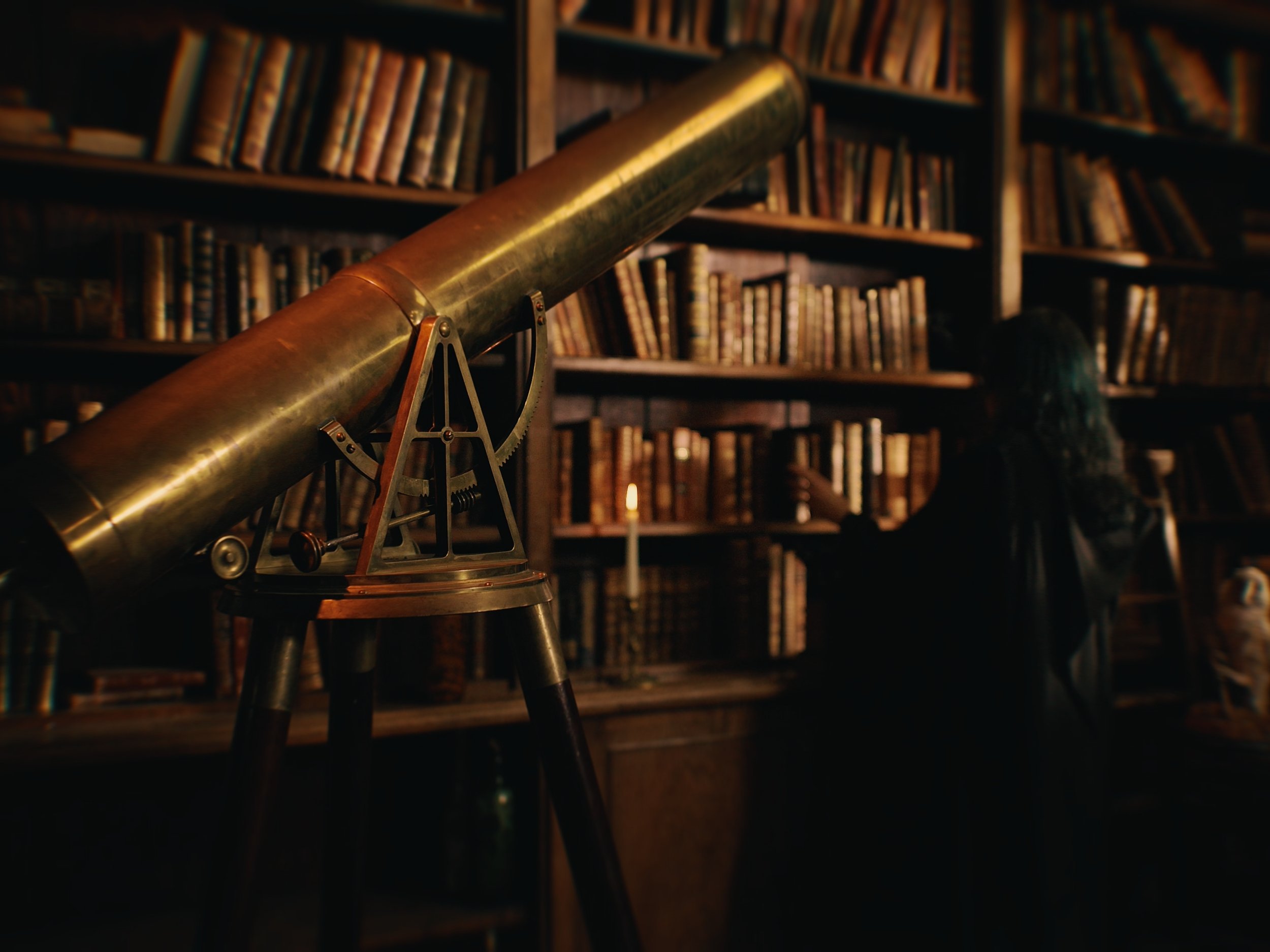 A witch blows out a candle in the library