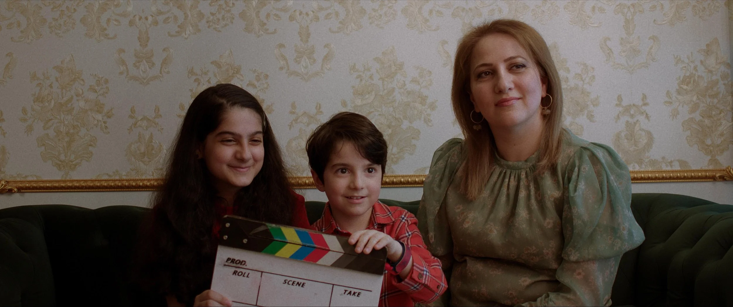 Zara and her family hold a clapperboard during their interview