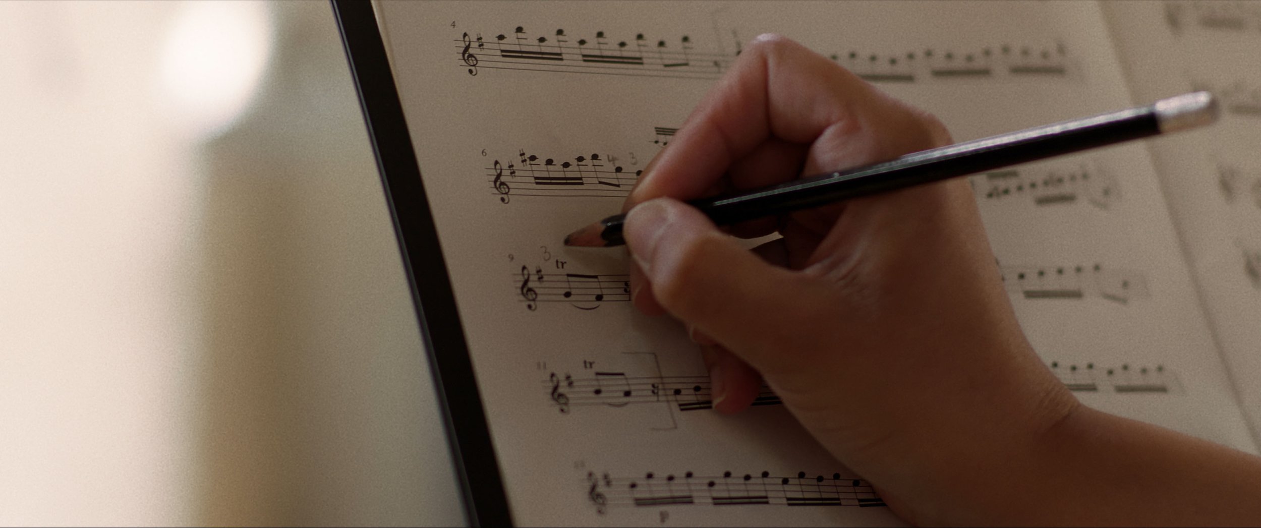 Zara makes a note on her music sheet