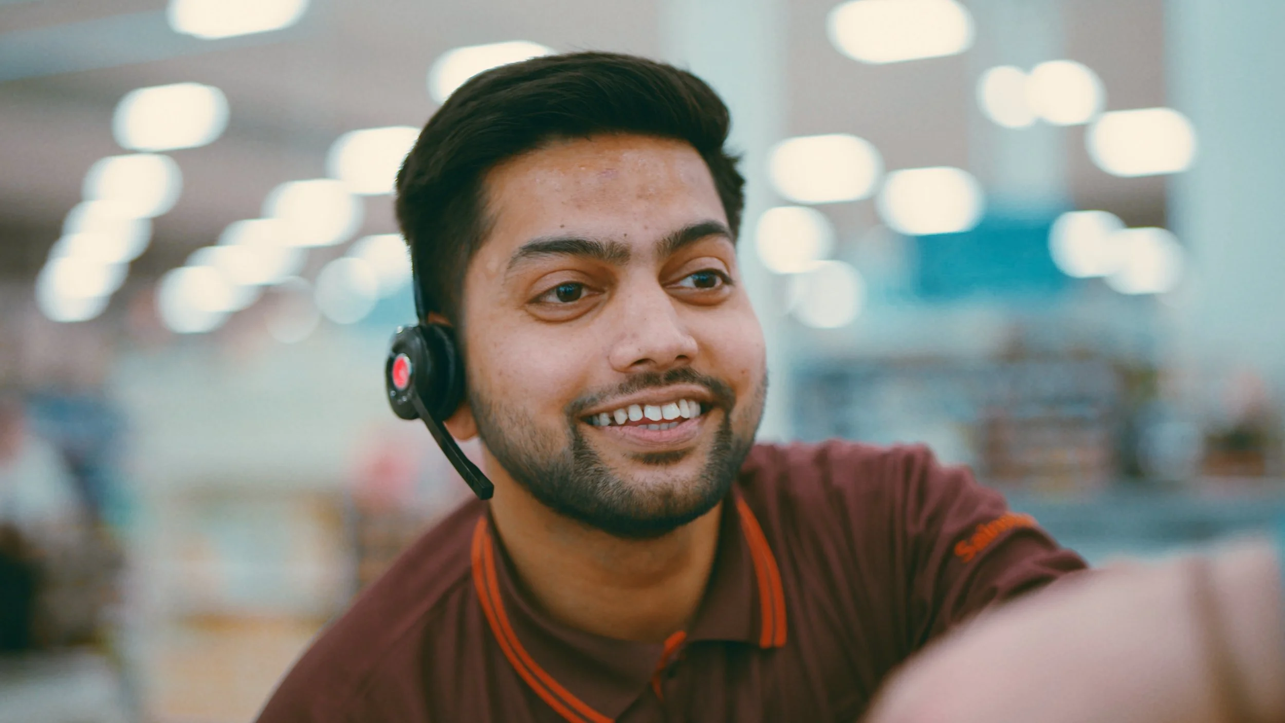 A Sainsburys worker hands over a bag of goods to a customer