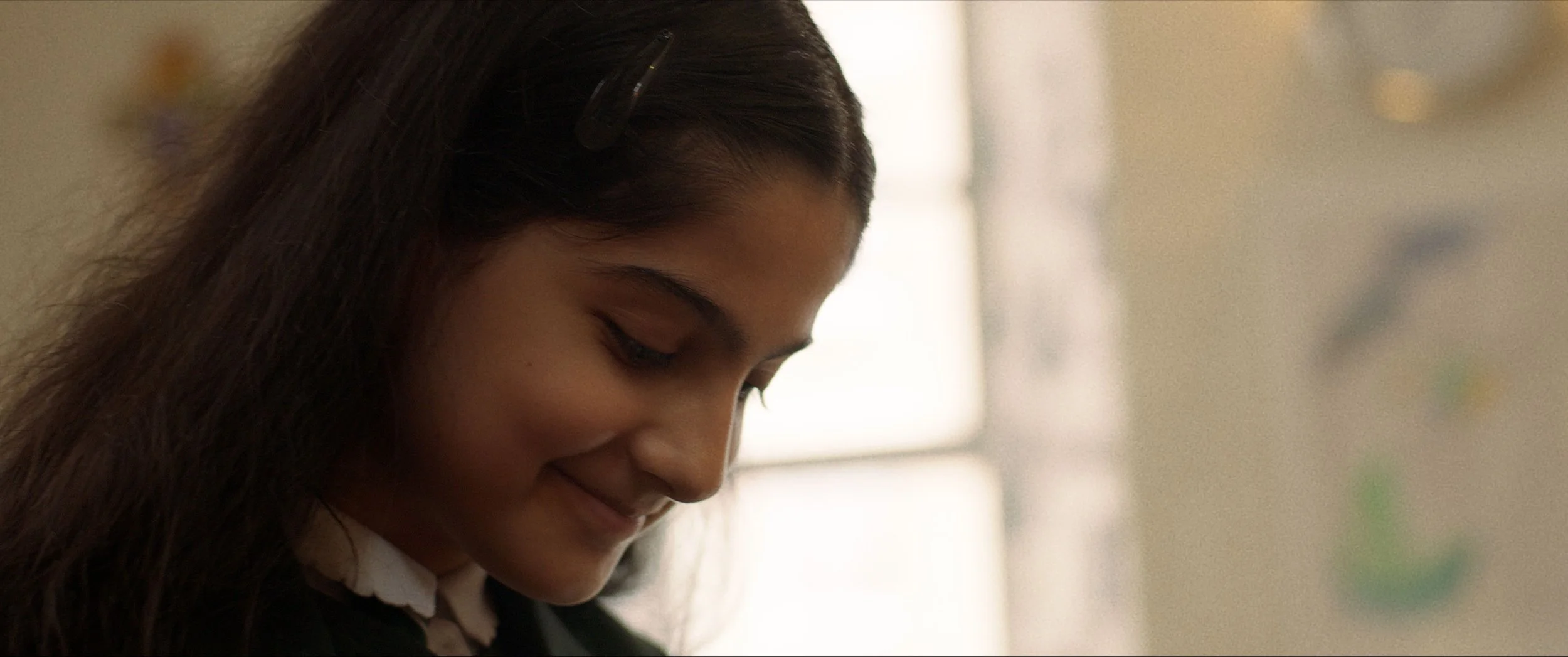 Zara smiles as she opens her violin case