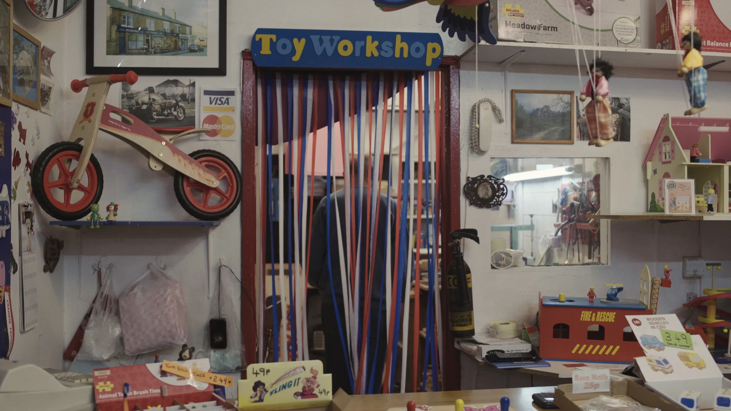 Rob Roy walks in his wood workshop