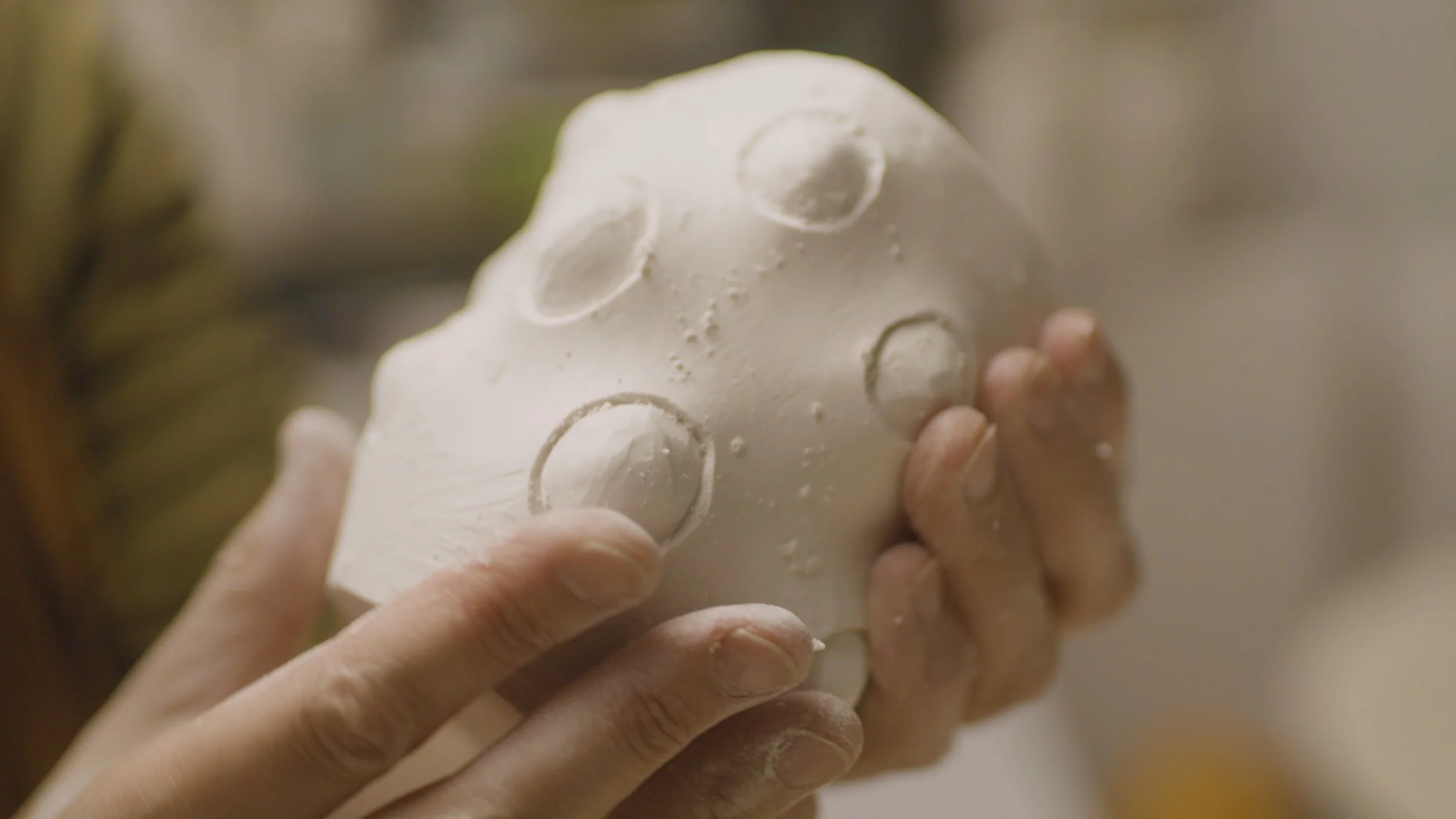 Ikuko Iwamoto holds something she is sculpting