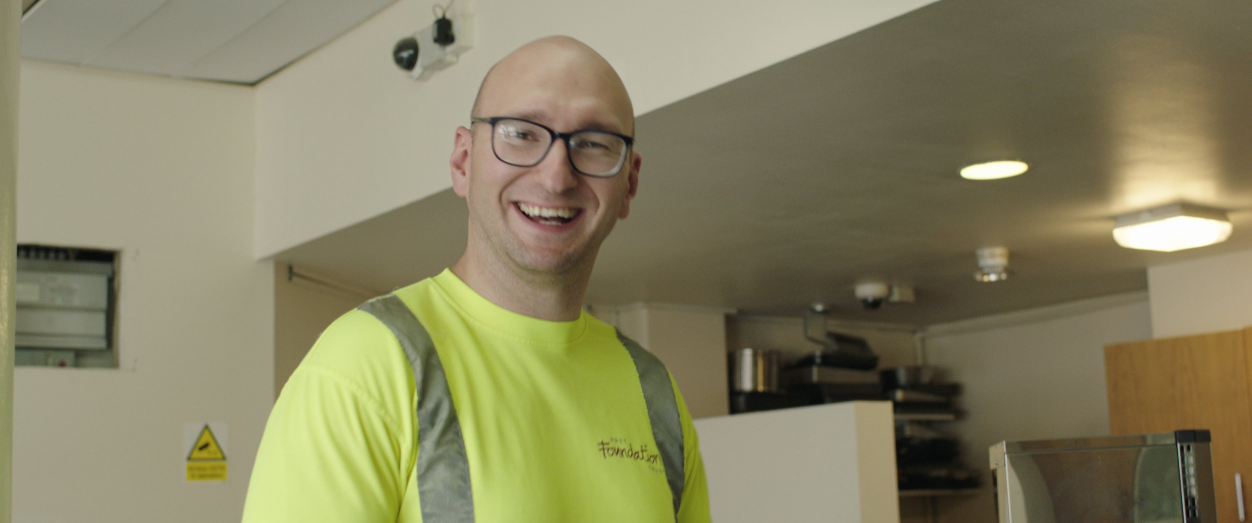 A Pret delivery driver smiles to camera