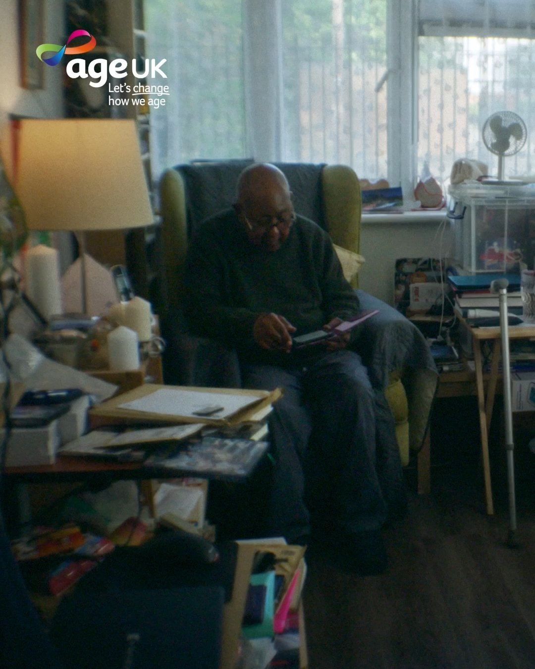 Michael reads his Kindle, Age UK