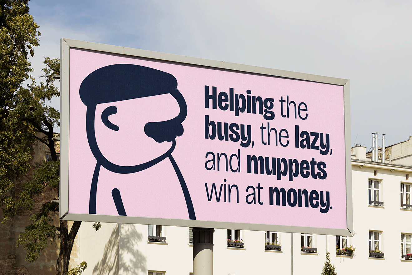 Billboard with a cartoon drawing of a man's face and the text "Helping the busy, the lazy, and muppets win at money" against a pink background, with buildings and trees in the background.