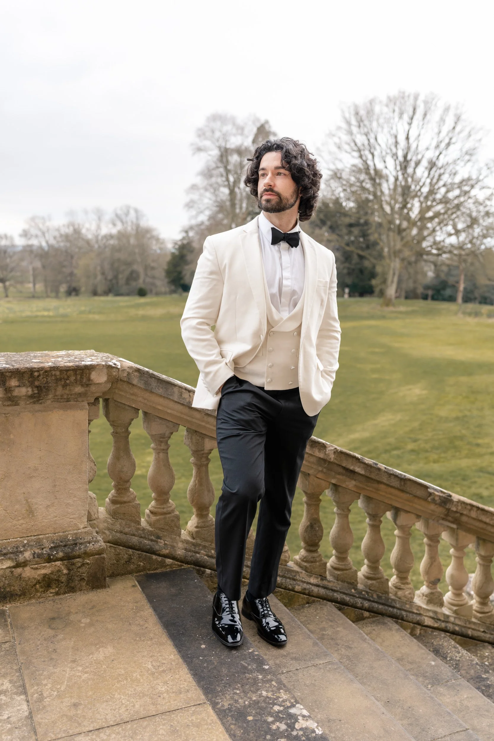 Groom waiting for his bride outside Kirtlington Park in Oxfordshire
