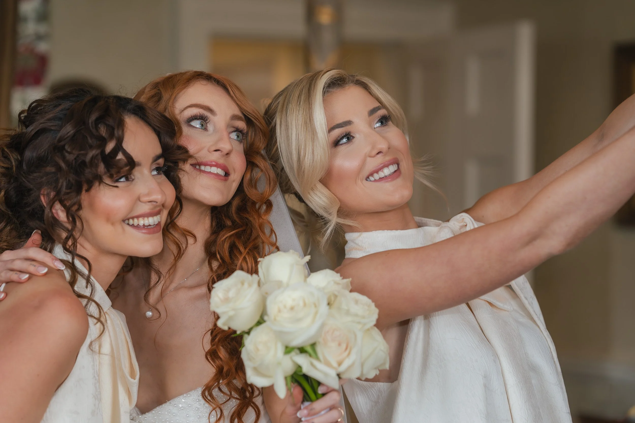 Bridesmaids and the bride taking a selfie in the bridal suite at Kirtlington Park in Oxfordshire