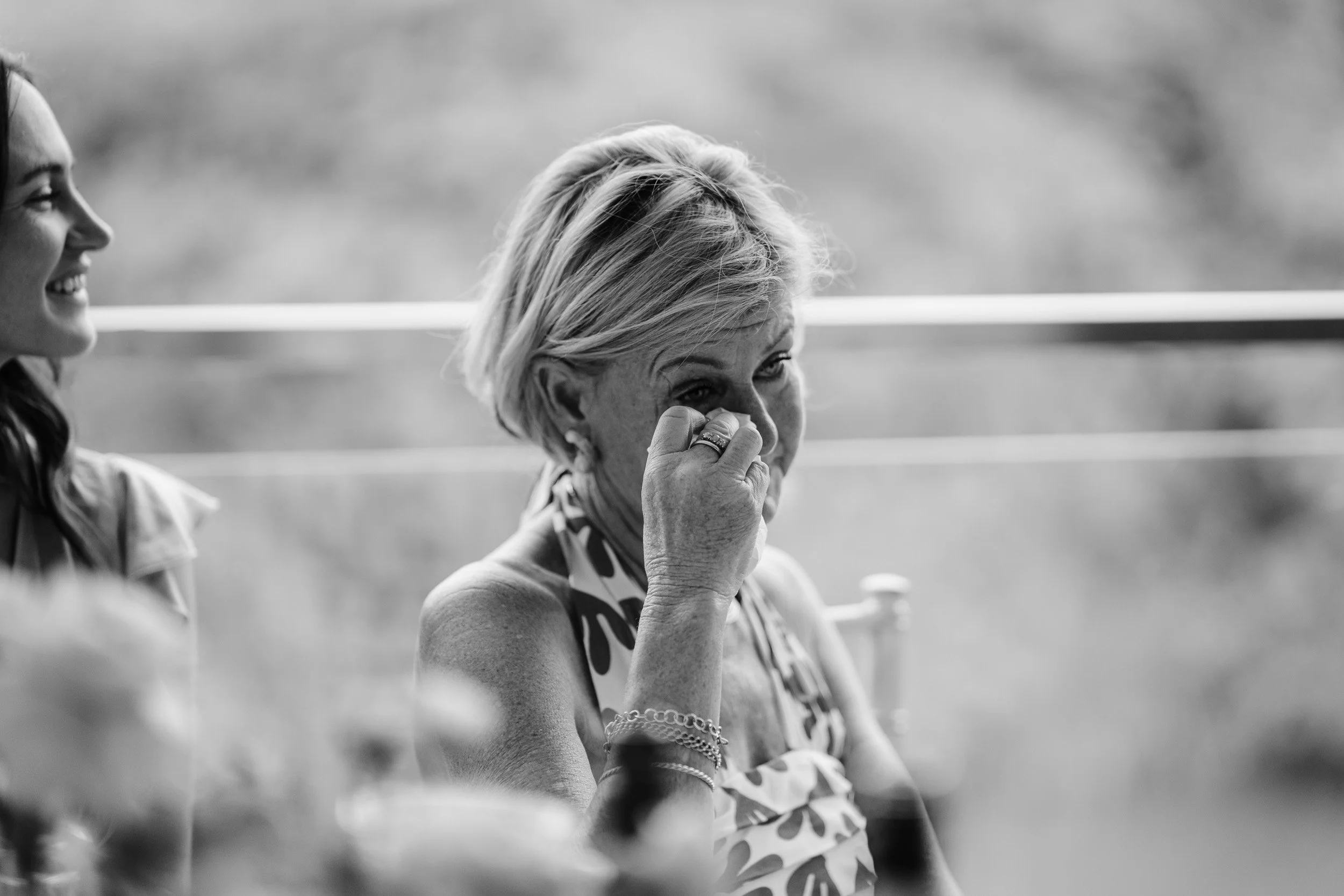 Mother of the bride tearfully reacting during the wedding speeches at Cherwell Boathouse in Oxford 