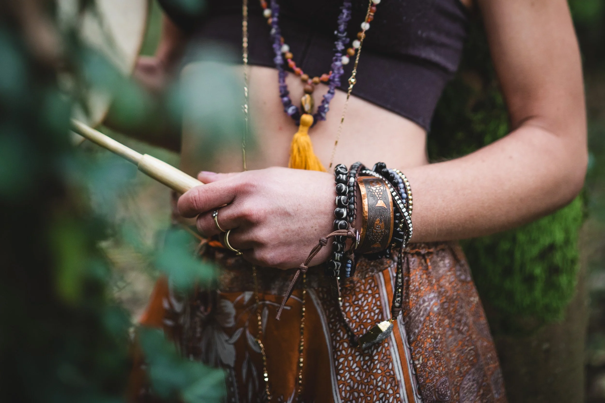 Sound healer wearing crystal bracelets for personal branding shoot in woodland near Amersham Buckinghamshire