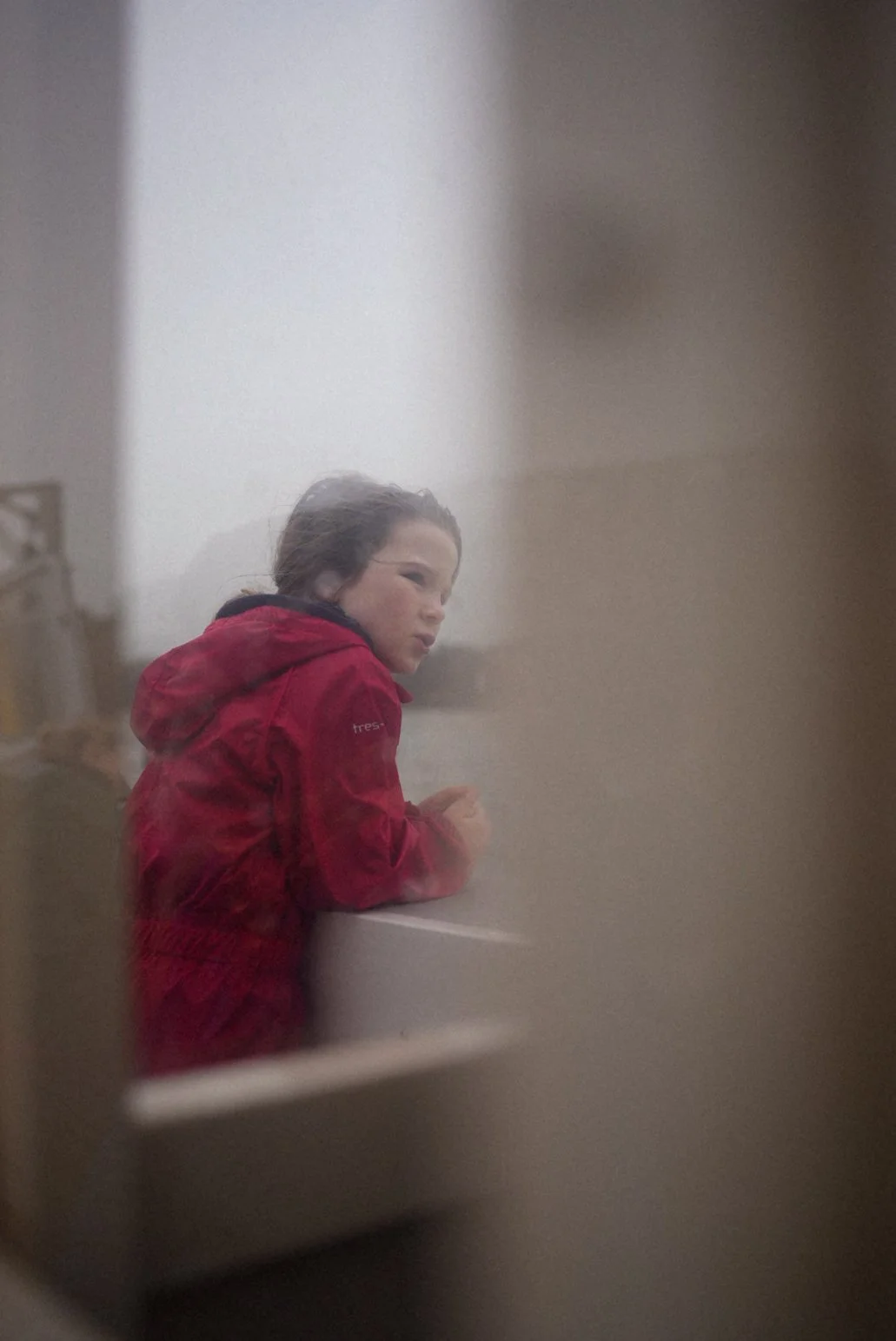 Child looking out across the water from Rock to Padstow in Cornwall