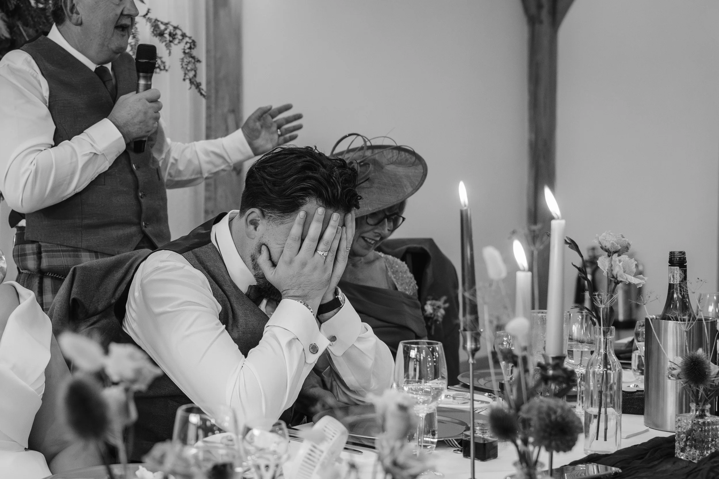Groom walking with his head in his hands during the wedding speeches at Rivervale Barn in Hampshire