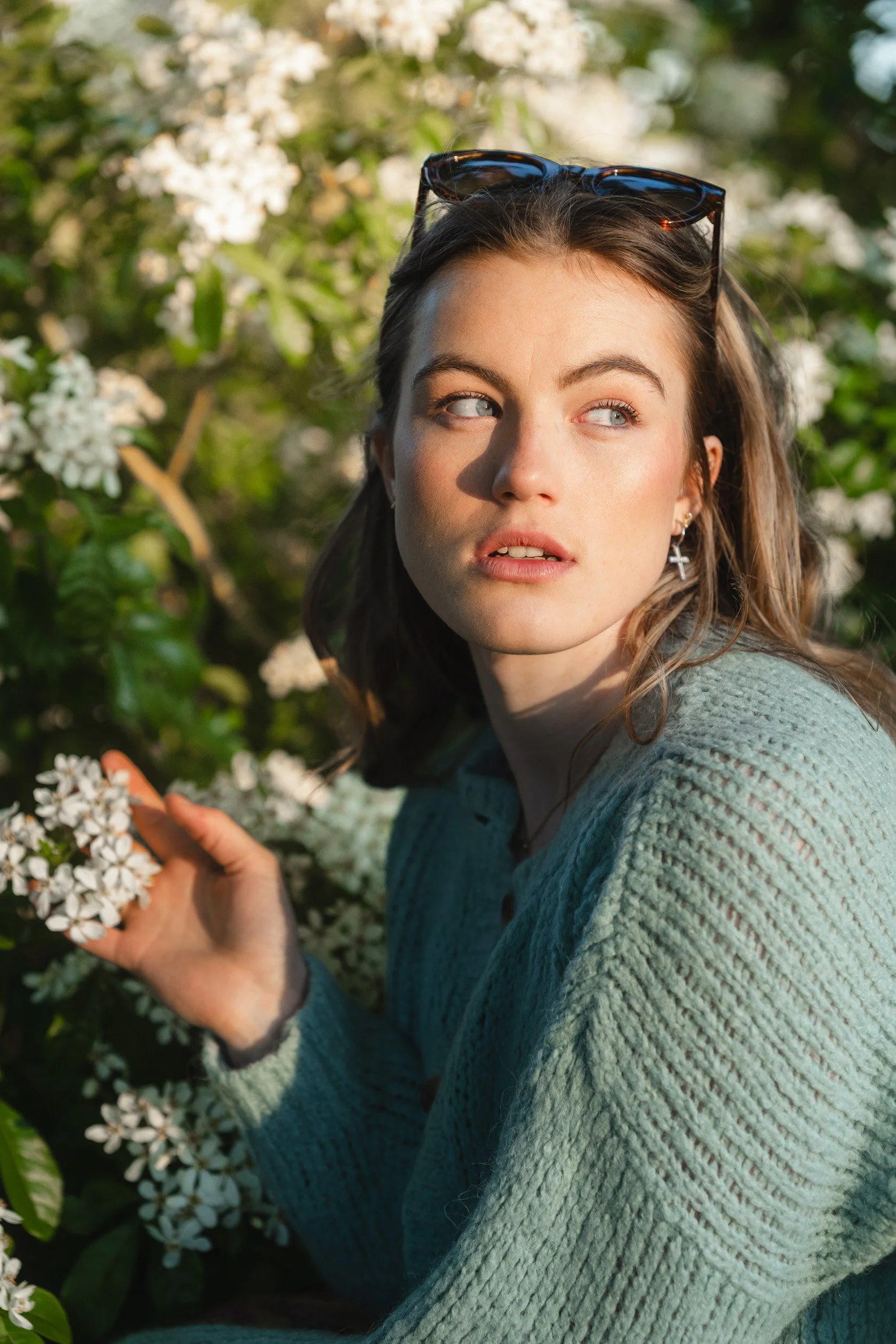 Close up of a teen girl portrait in the white flowers during a golden hour school leaver photography session in Amersham, Buckinghamshire