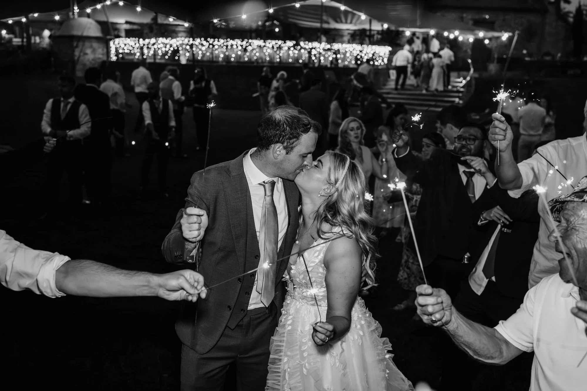 Bride and groom kissing at the end of their sparkler send-off at their Wasing Park wedding in Berkshire