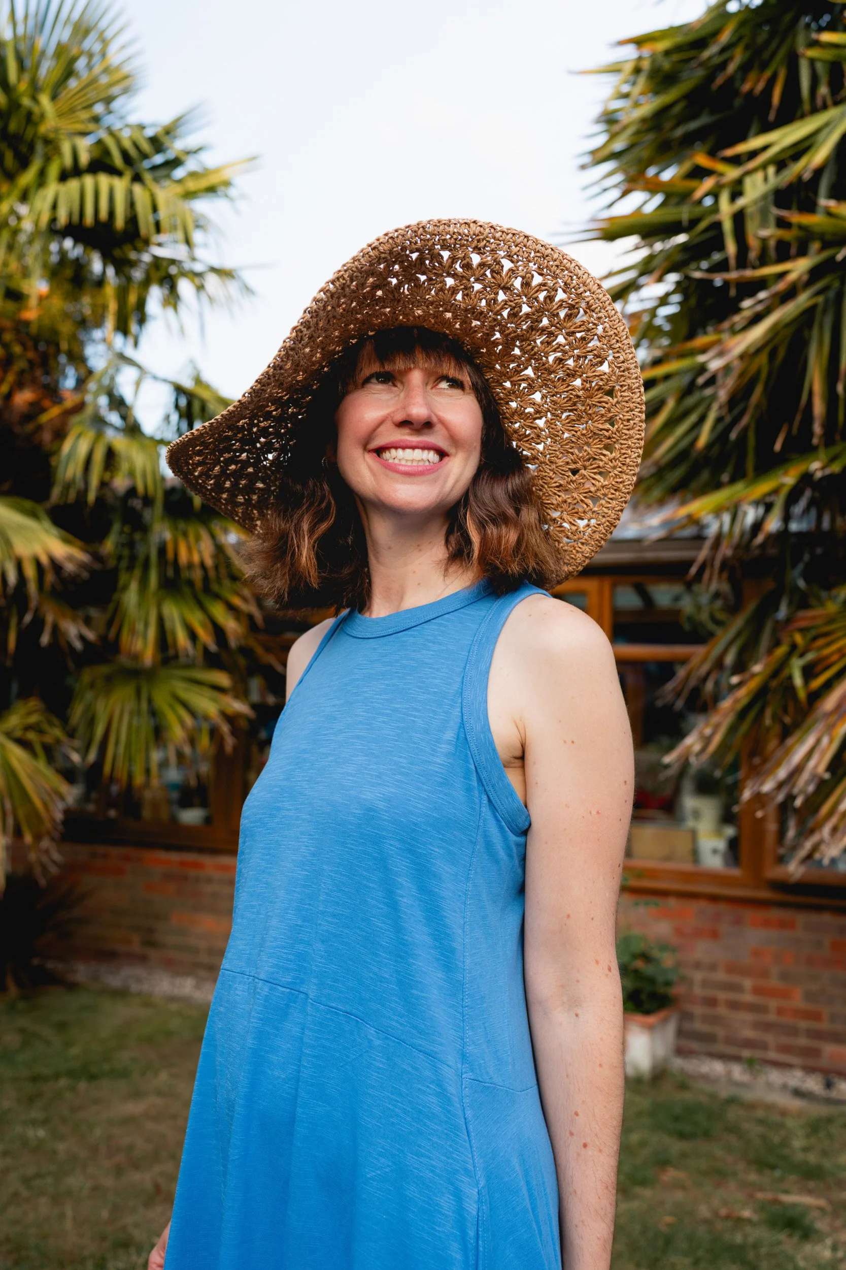Mother smiling in a garden during a relaxed motherhood photography session in Amersham, Buckinghamshire
