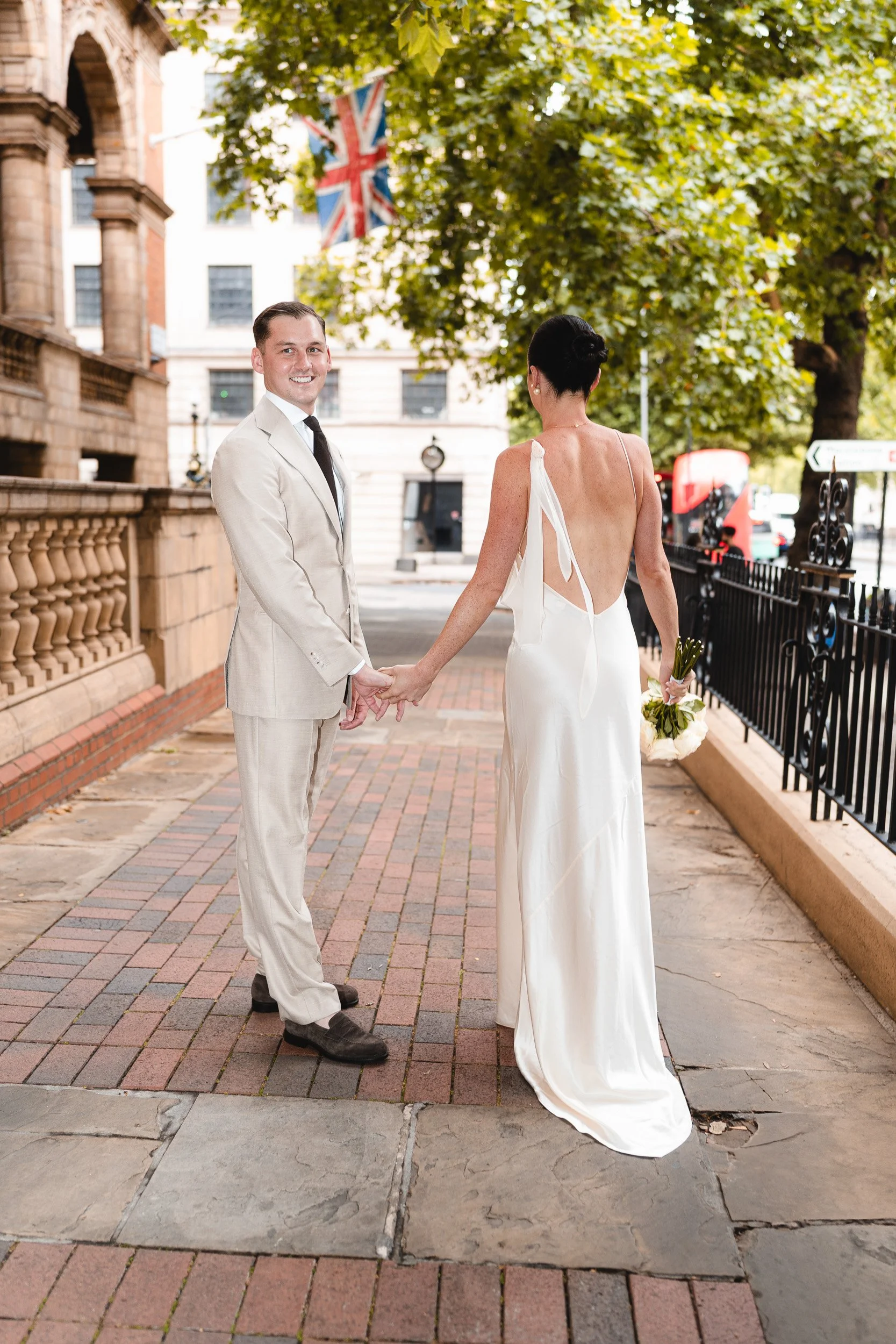 Bride and groom standing outside The Landmark Hotel on the way to their wedding ceremony at Marylebone Registry Office in London