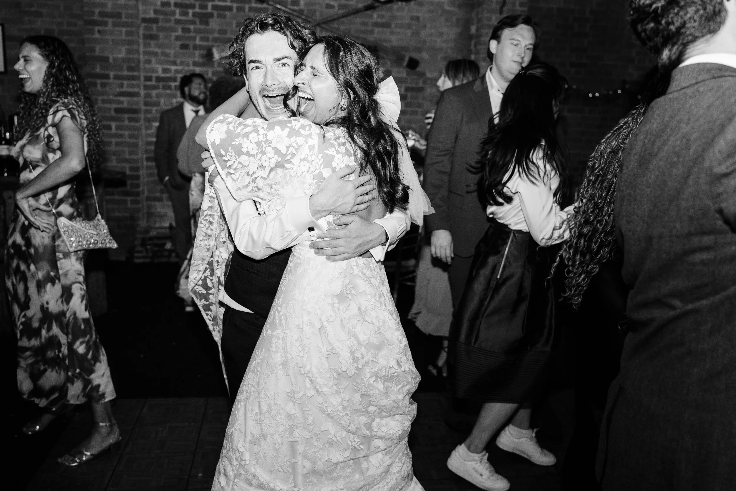 Bride laughing and dancing with her best friend a her wedding reception at Cherwell Boathouse in Oxford 