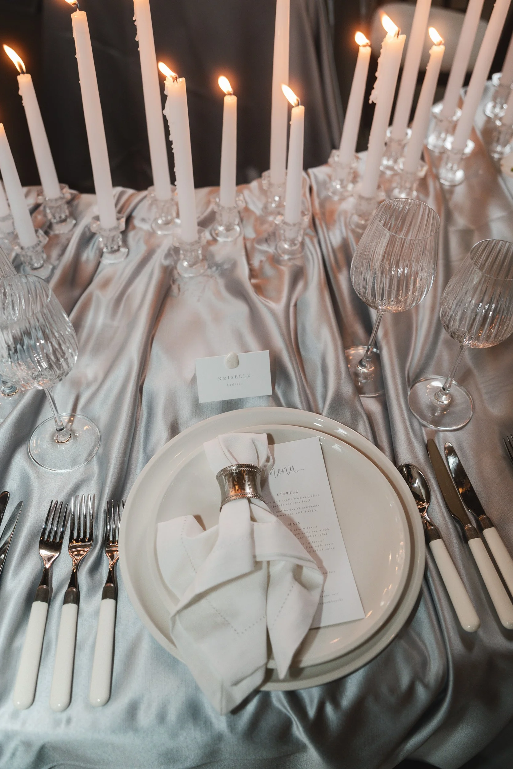 Candlelit wedding reception table setting inside The Bell Tower at The Elvetham Hotel in Hampshire