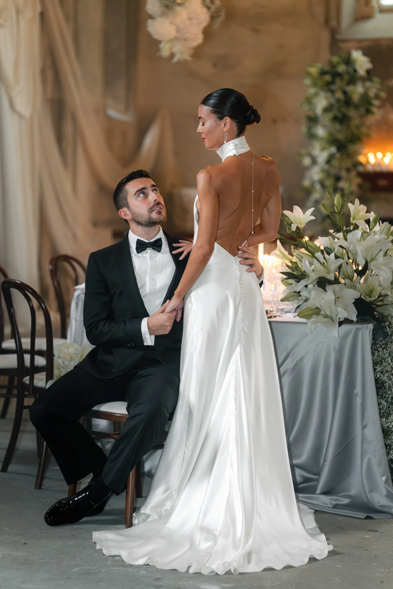 Bride and groom walking hand in hand in front of The Bell Tower at The Elvetham Hotel in Hampshire