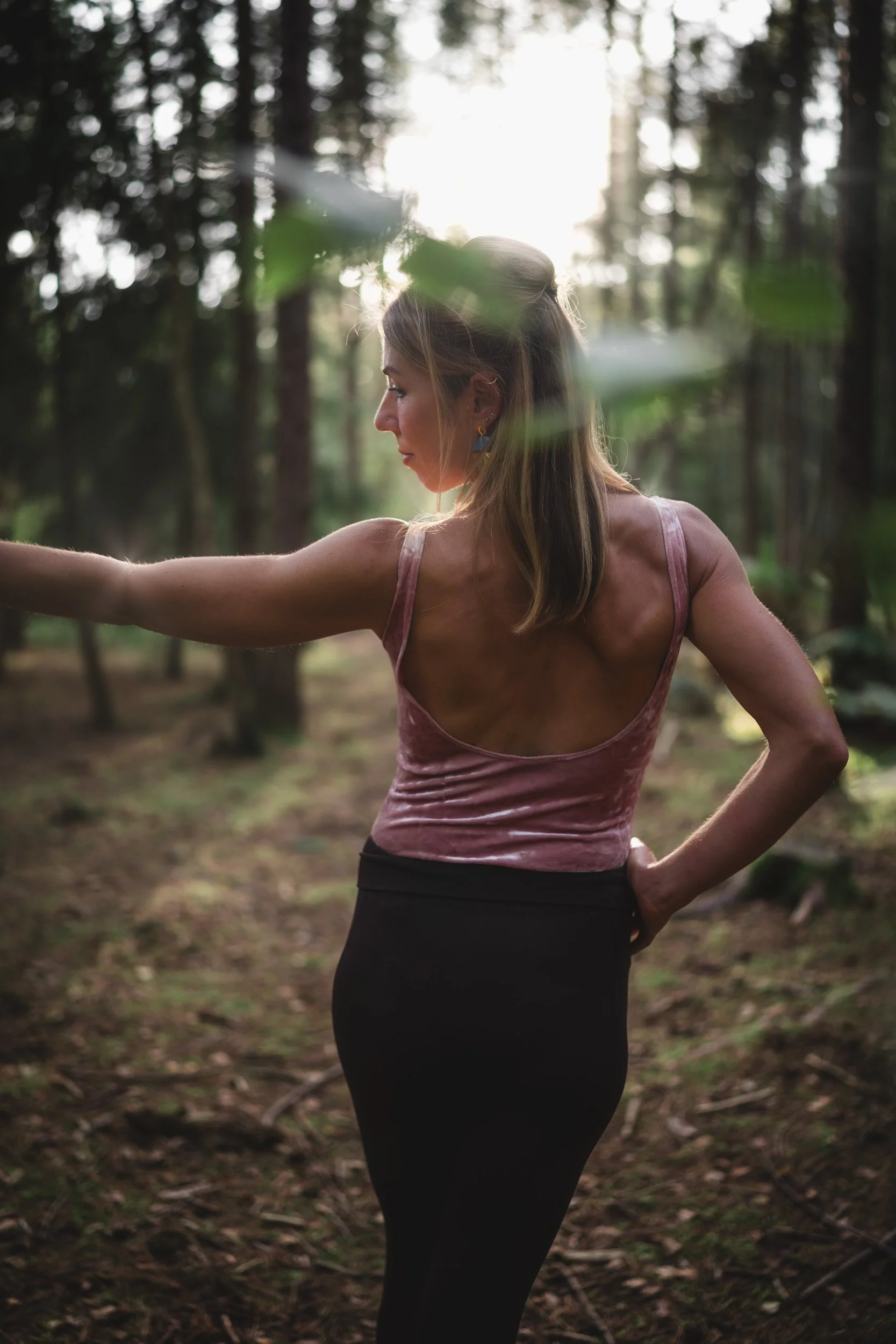 Yoga trainer practicing standing in the woodland during a personal branding photoshoot in Black Park Buckinghamshire