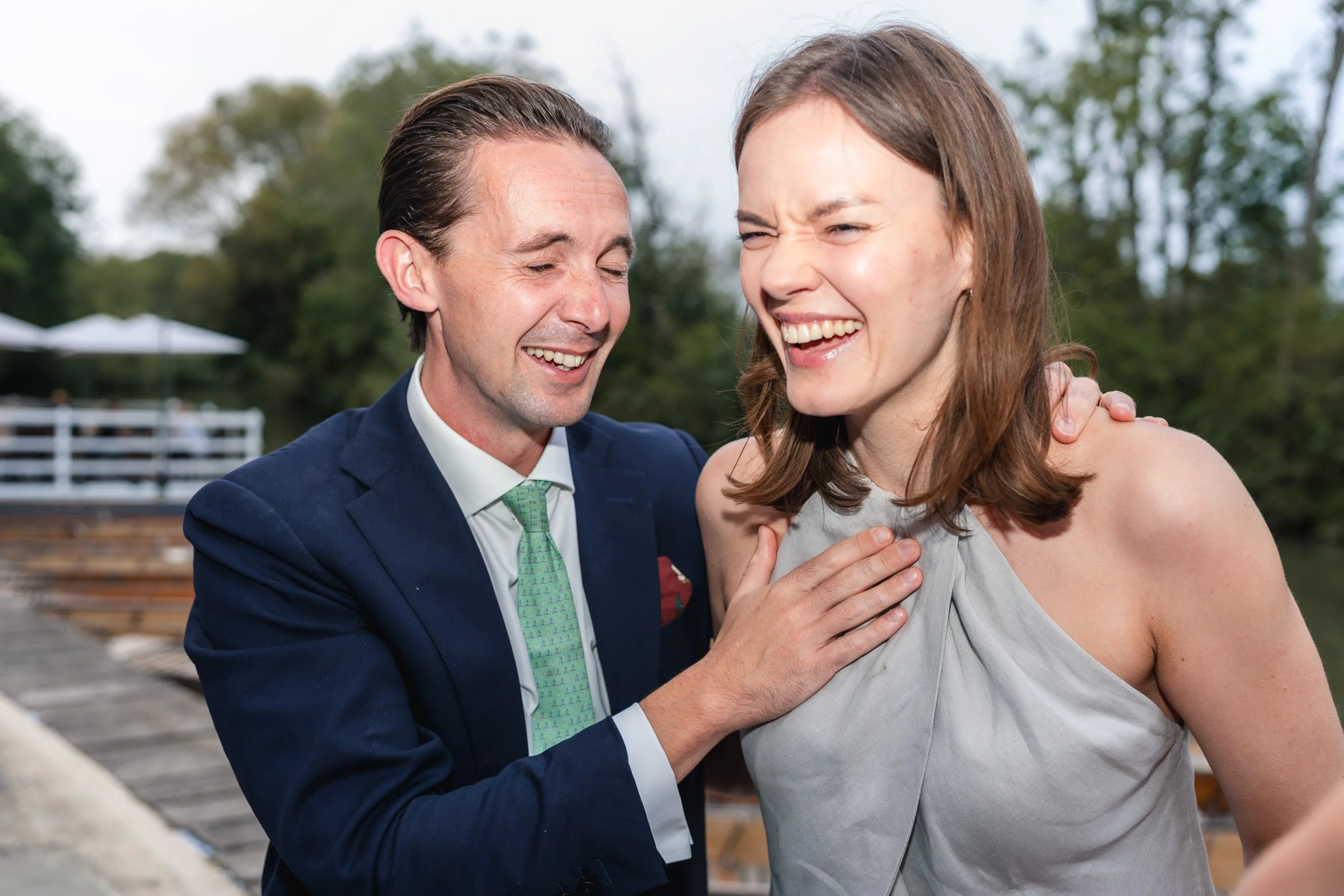 Happy laughing guests at a wedding reception at Cherwell Boathouse in Oxford 