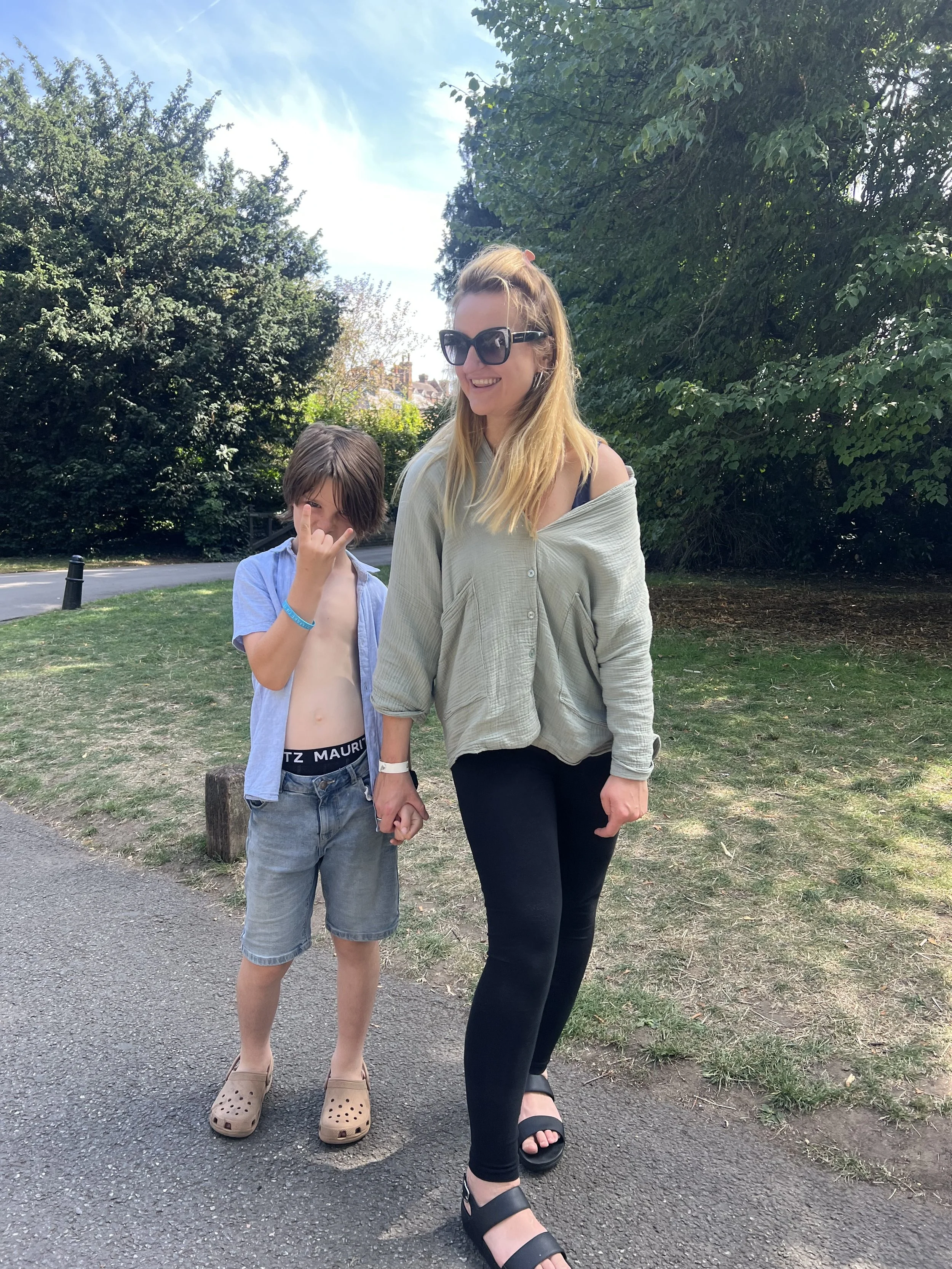 Mother and son laughing together in the gardens of Hampton Court Palace