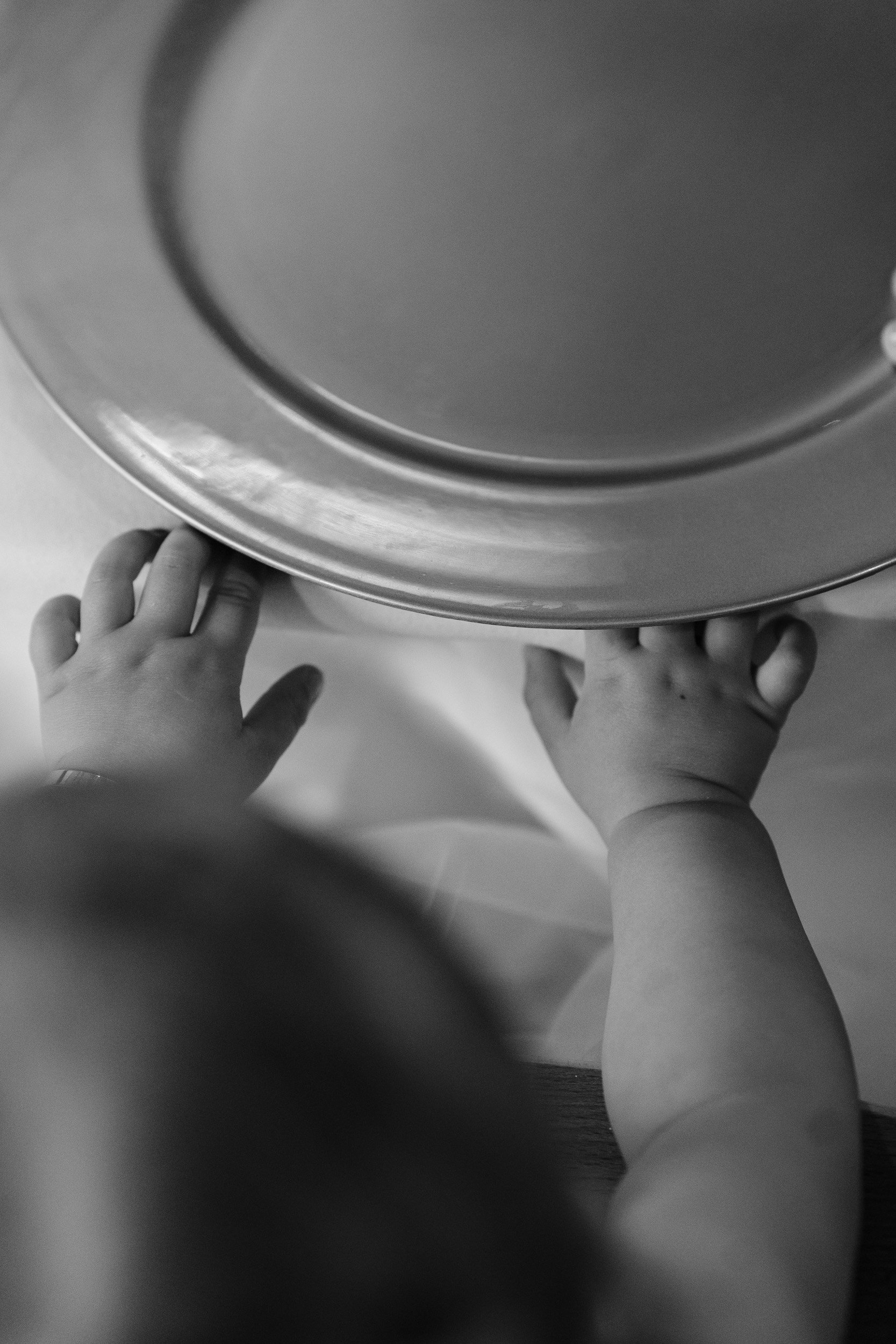 Black and white detail of bride and grooms baby at their place setting during the wedding reception dinner at Rivervale Barn in Hampshire