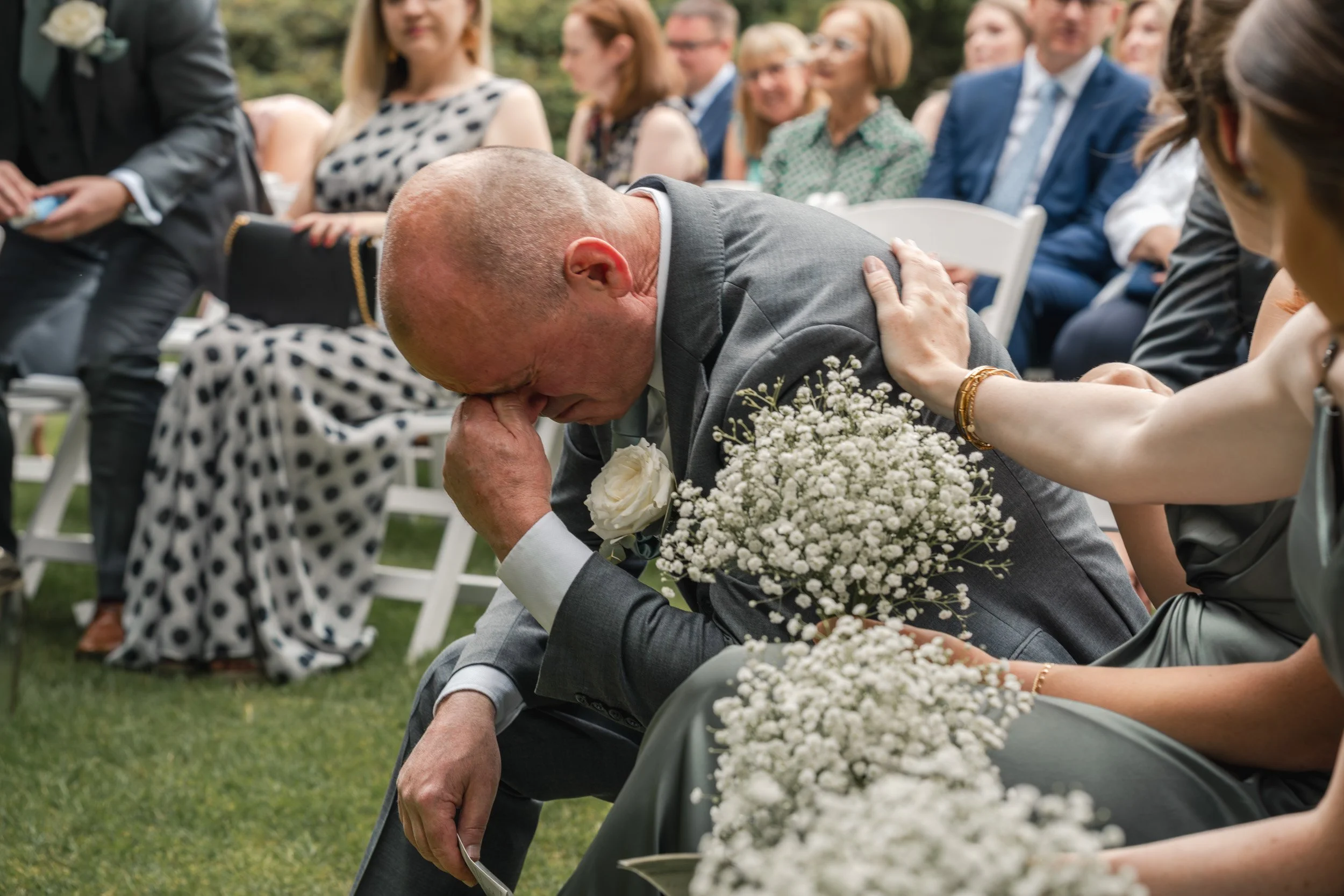 Father of the bride crying happy tears as the bride and groom say I do at an outdoor garden ceremony  Wasing Park in Berkshire
