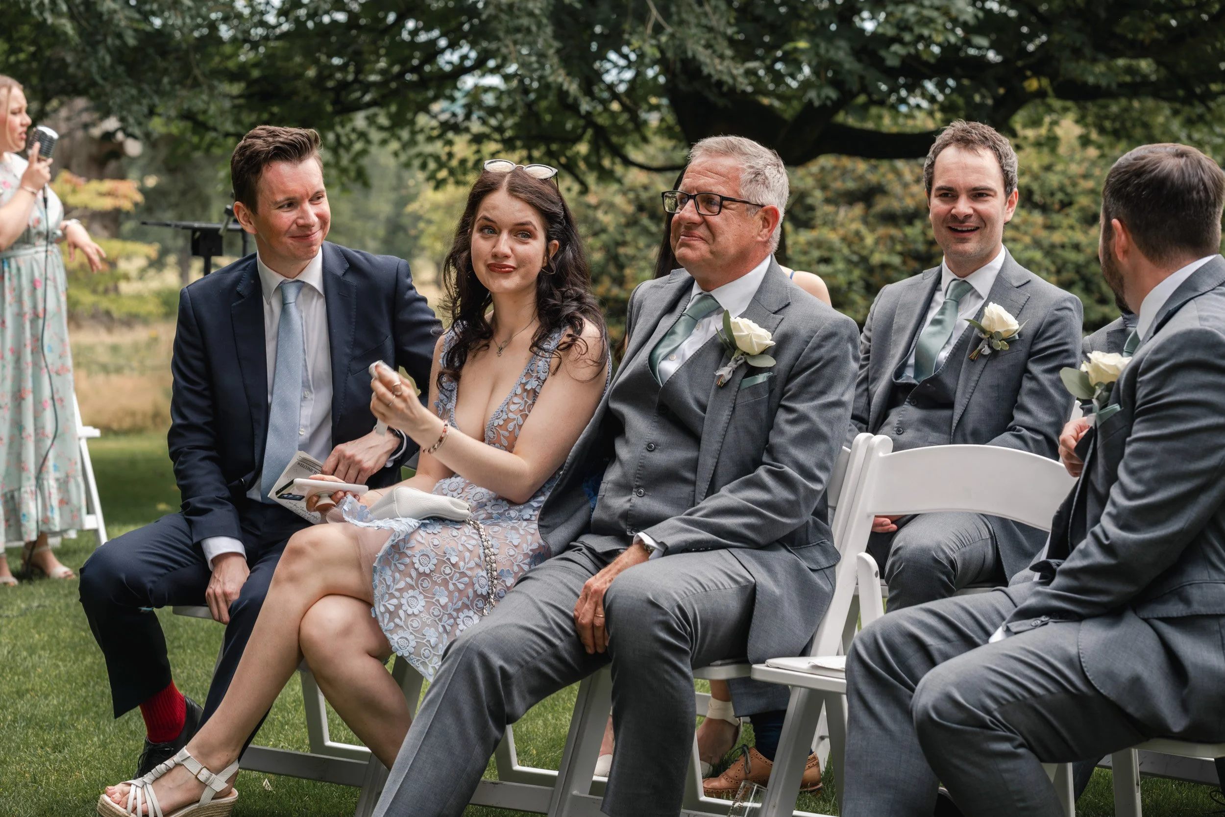 Wedding guest wiping away happy tears as the bride and groom say I do at an outdoor garden ceremony  Wasing Park in Berkshire