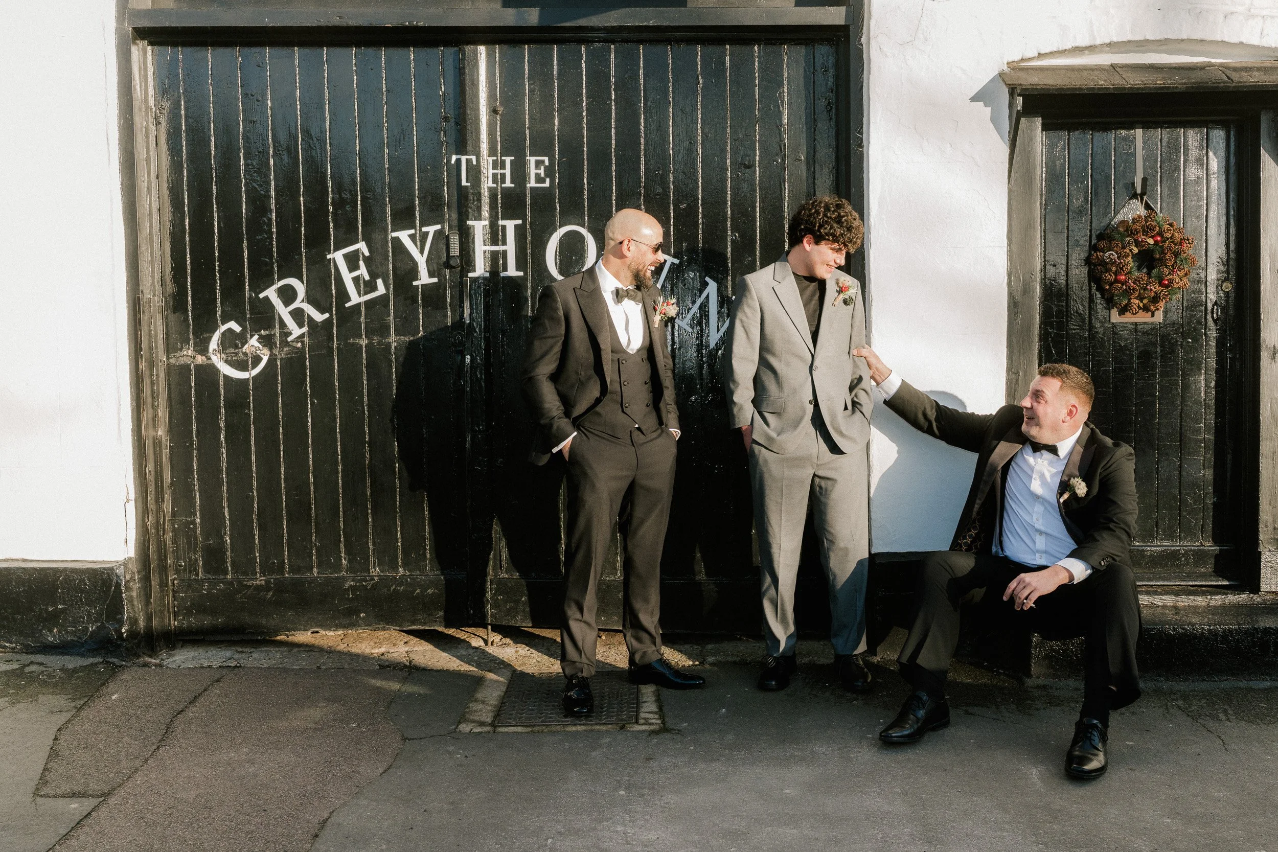 Groom, his brother and best man waiting outside The Greyhound in Old Beaconsfield Buckinghamshire before their wedding ceremony at Beaconsfield Registry Office