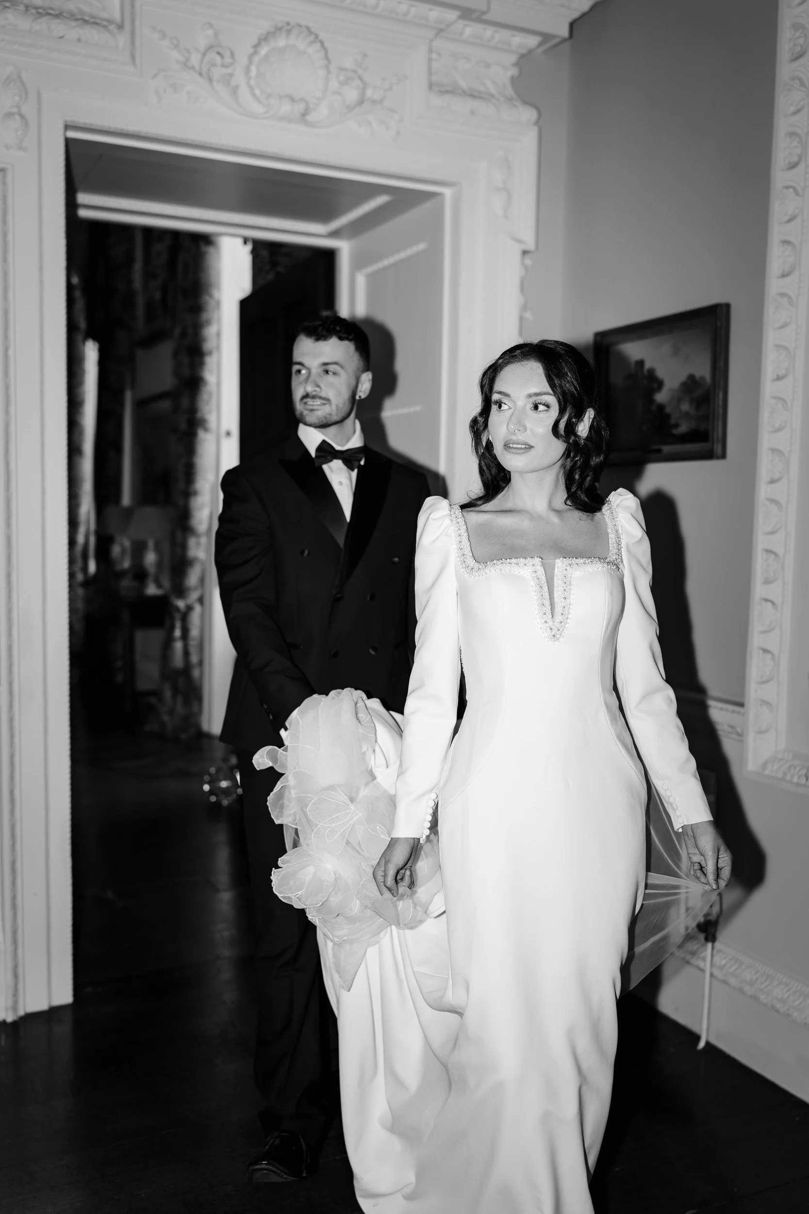 Bride and groom walking into their wedding reception at Kirtlington Park in Oxfordshire