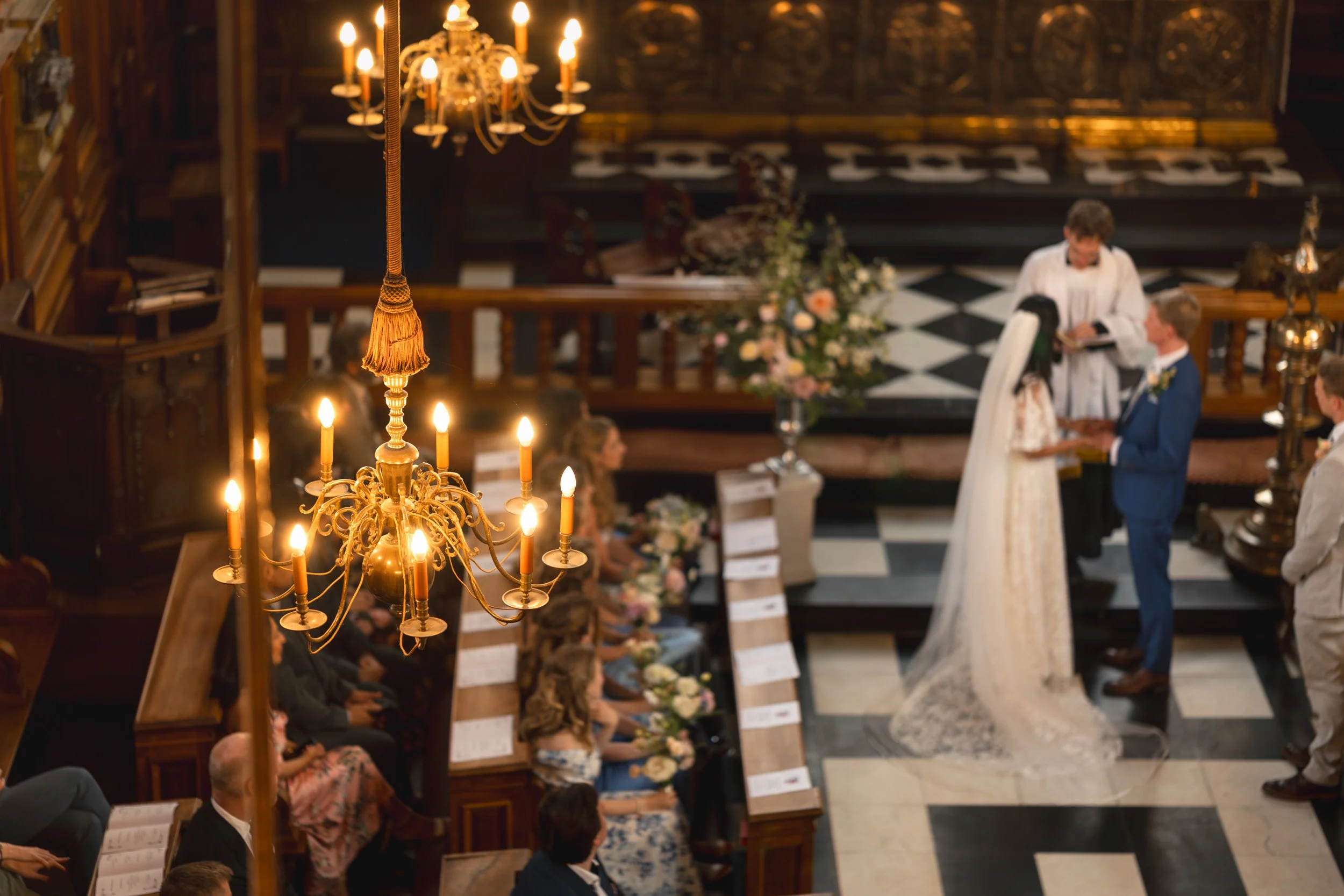 Bride and groom saying " I do" during their wedding ceremony in an Oxford University college chapel in Oxford, Engand