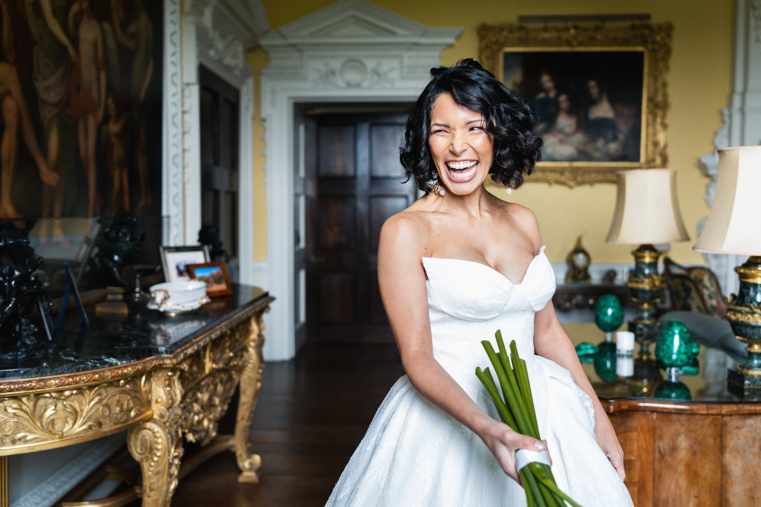 Bride laughing during her wedding reception at Kirtlington Park in Oxfordshire