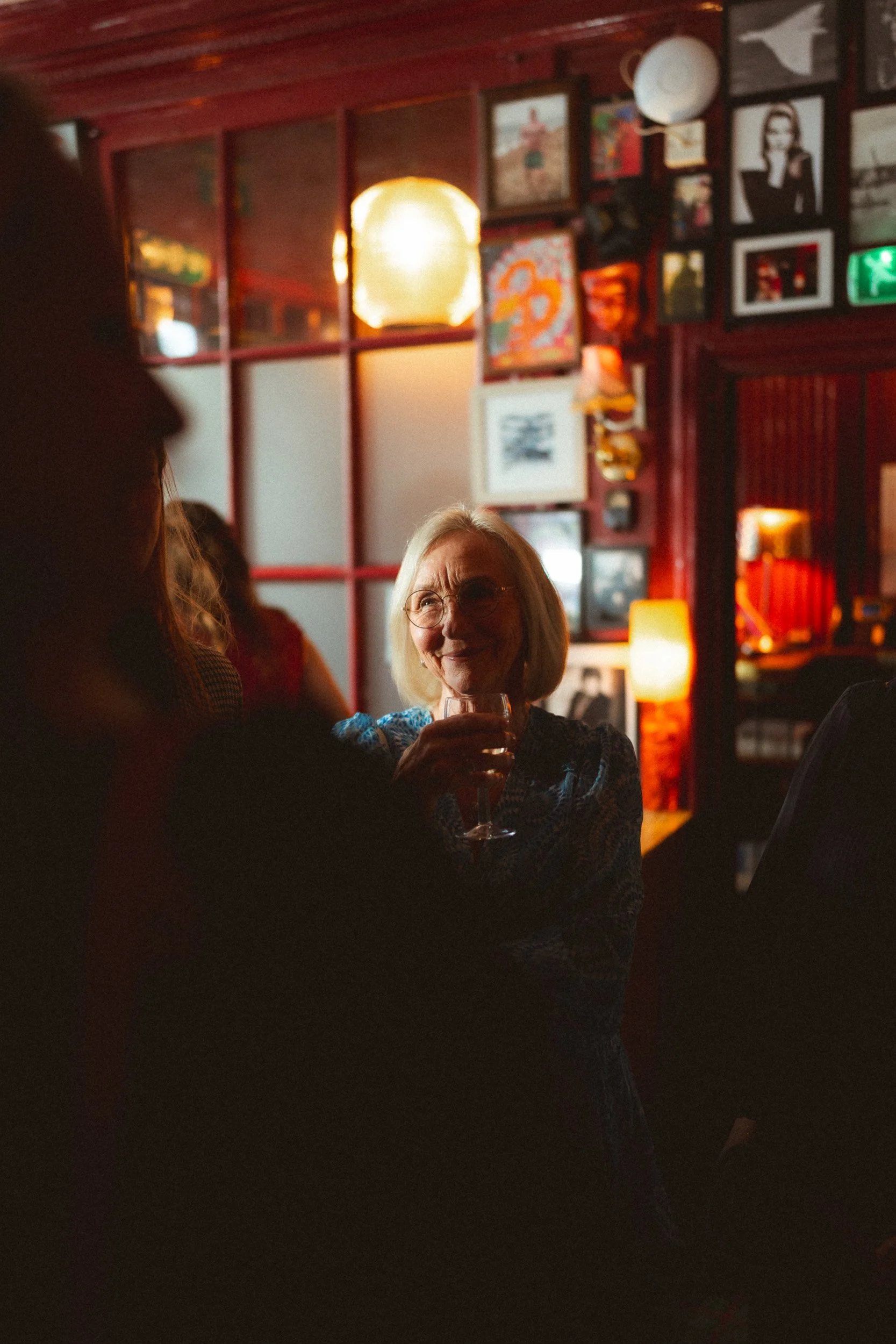 Mother of the bride raising a toast during the wedding reception as guest mingle