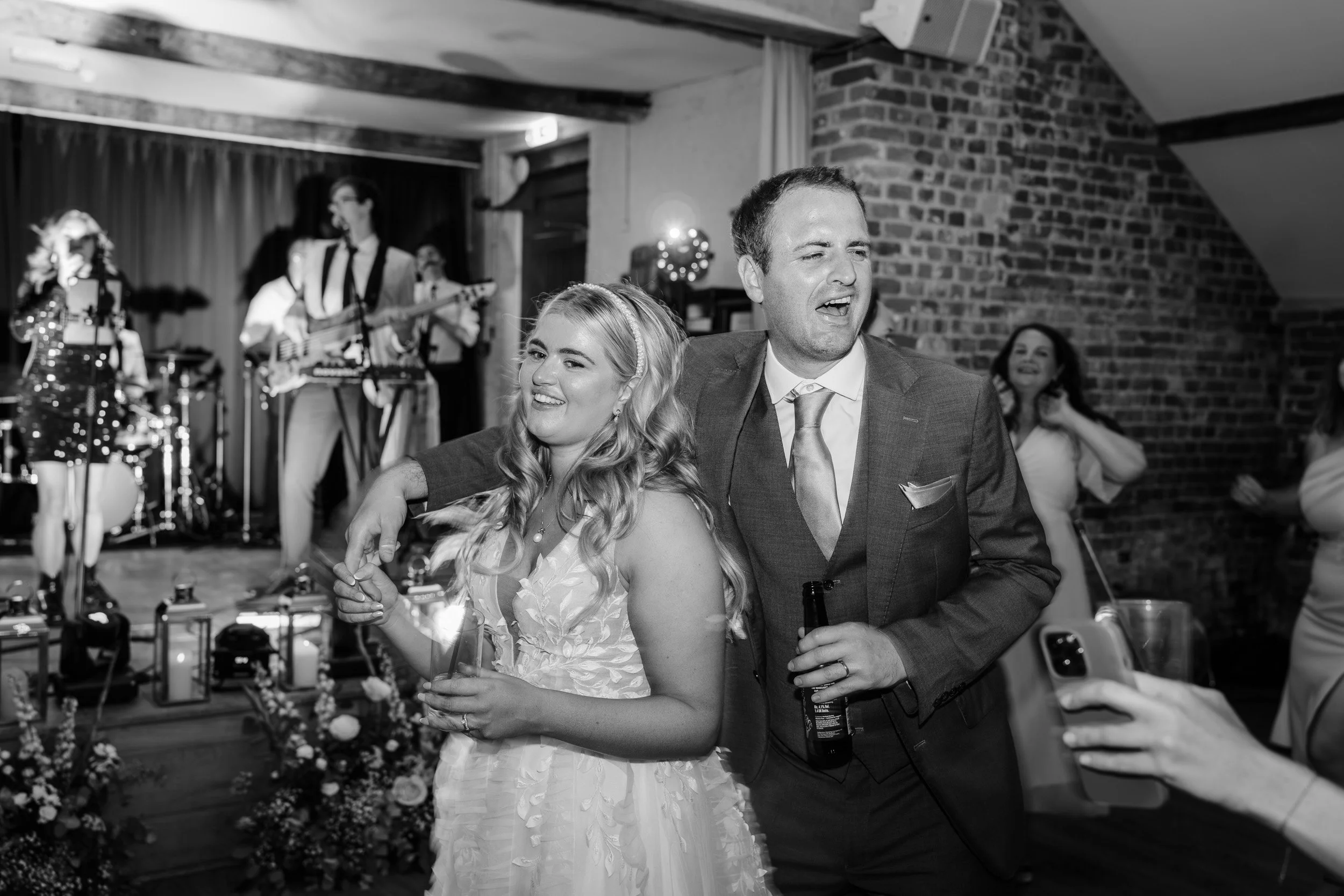 Bride and groom tired but happy at the end of their wedding reception having their last dance