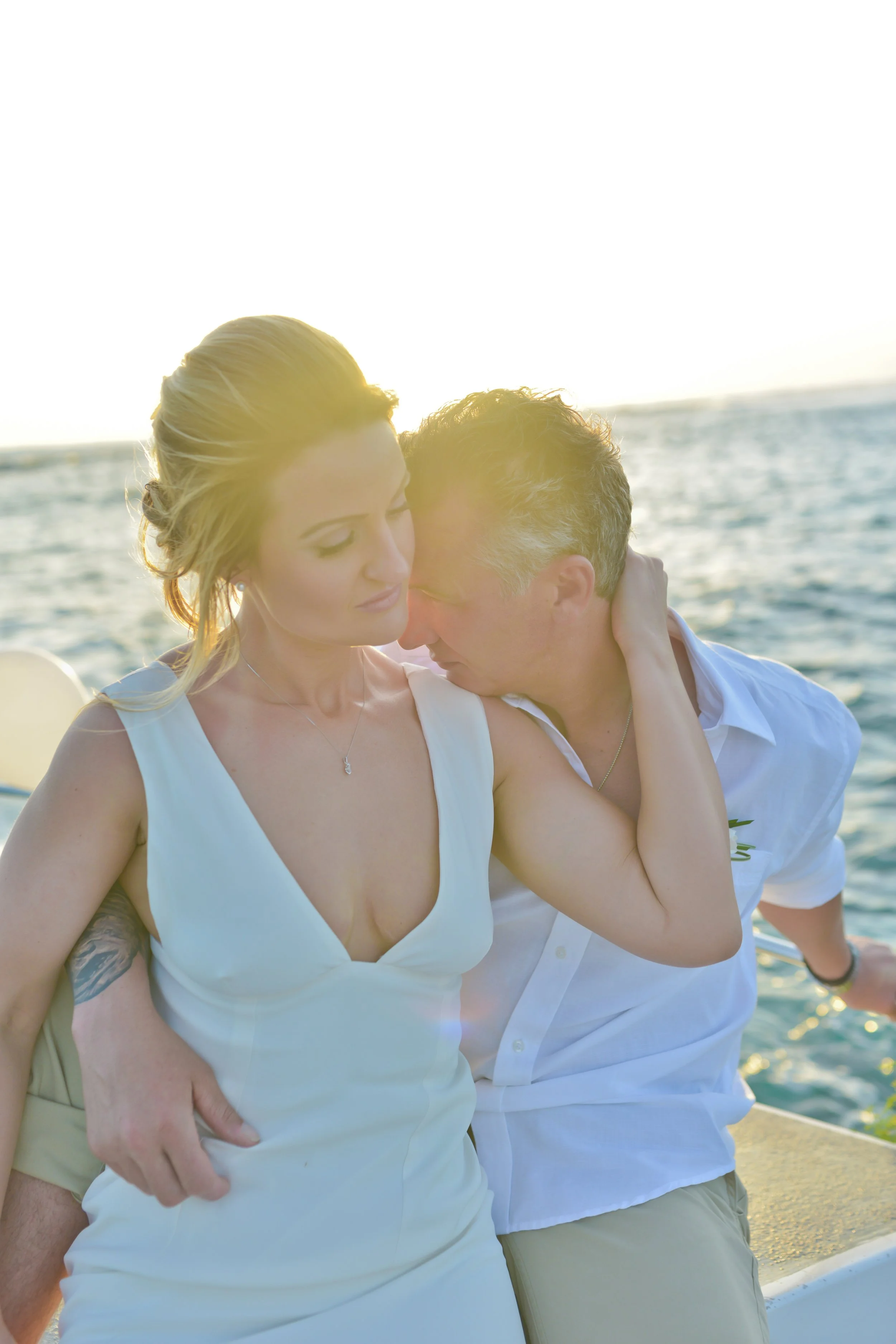 Bride and groom on a wedding boat at golden hour during their Mauritius elopement 