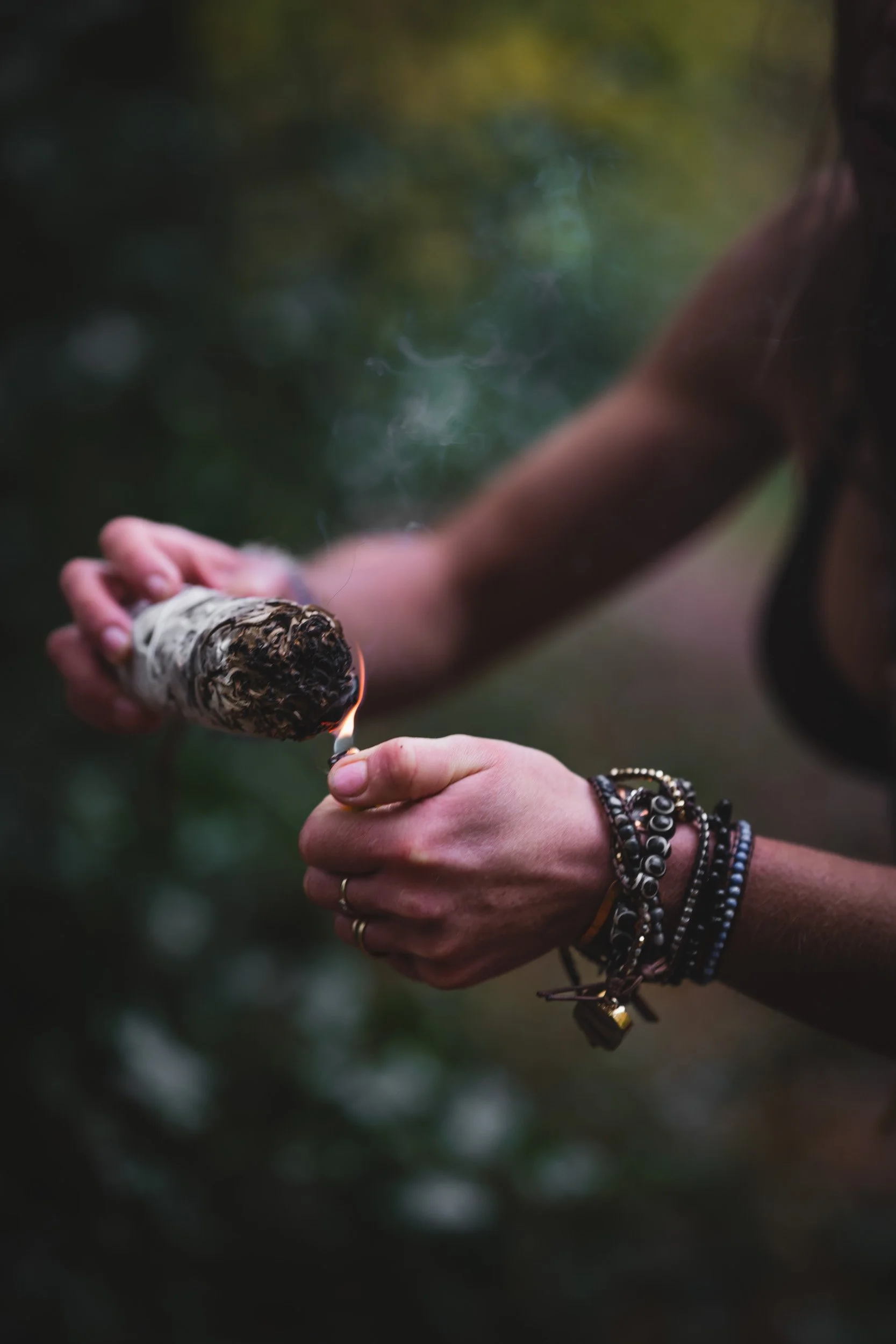 Sound healer lighting sage for a  branding shoot in the woodland near Amersham Buckinghamshire