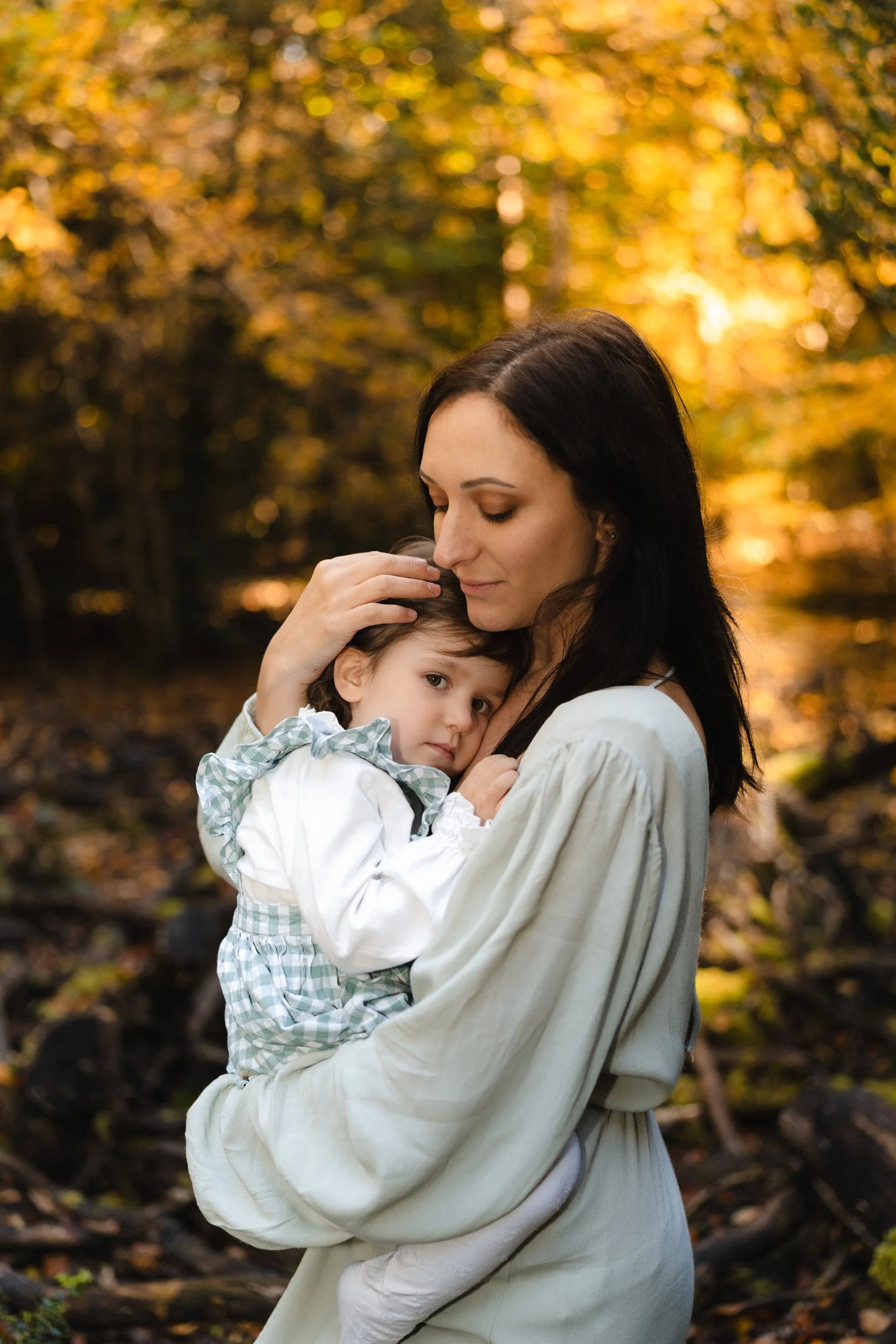 Mother embracing her toddler during an empowered woodland motherhood session in Buckinghamshire