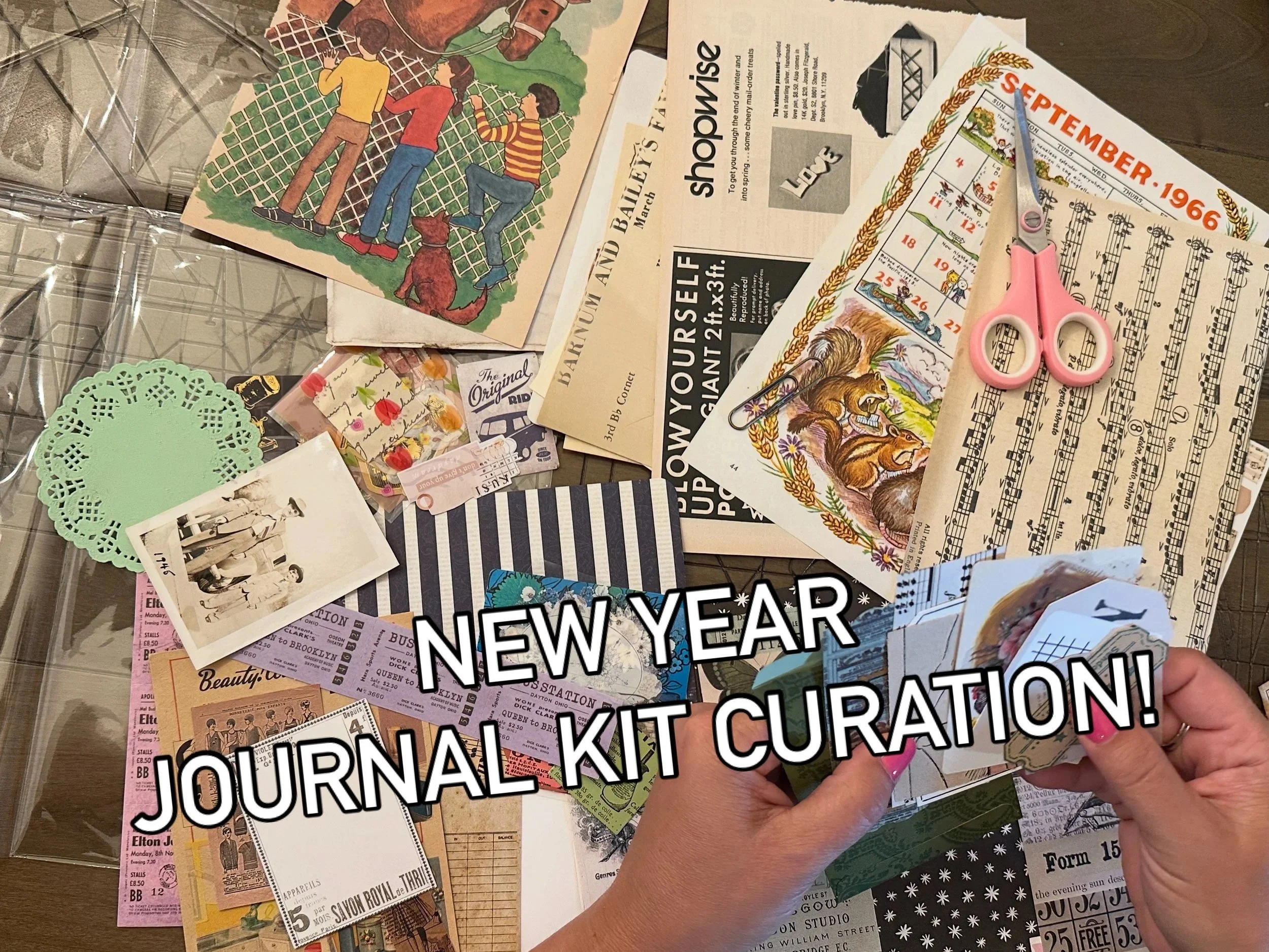 Showcasing assembly of a vintage journal kit highlighting an ephemera collage with postcards, sheet music, calendars, craft supplies, pink scissors.