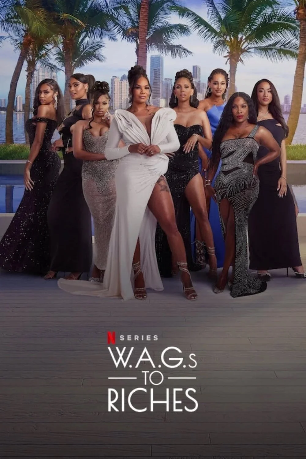 A group of nine women dressed in elegant evening gowns posing outdoors with palm trees and city skyscrapers in the background, promoting the Netflix series "Wags to Riches."