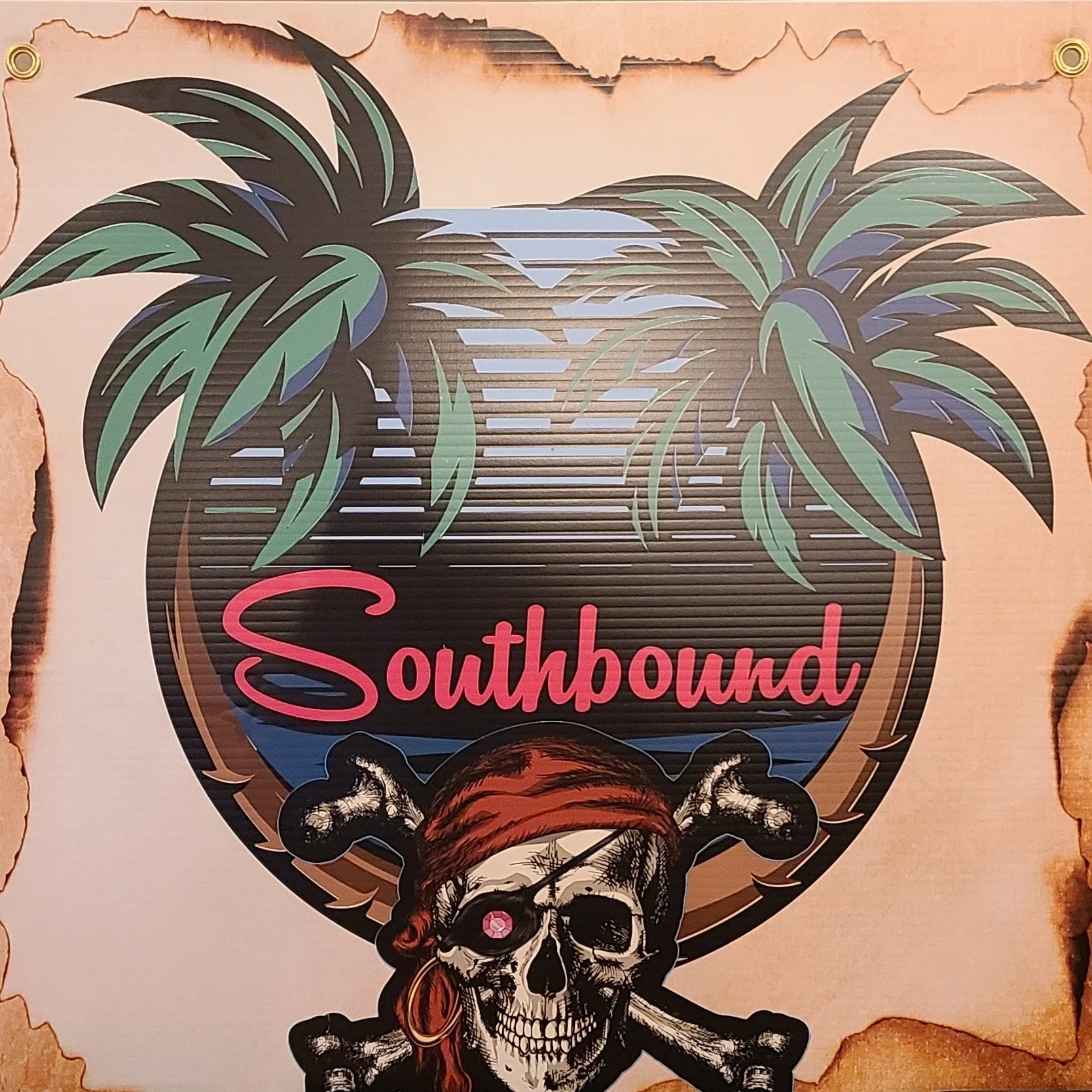 A sign with a skull wearing a red bandana and an eyepatch, two crossed bones behind it, and a large tropical palm tree with green and purple leaves. The word 'Southbound' is written in pink inside the sign.