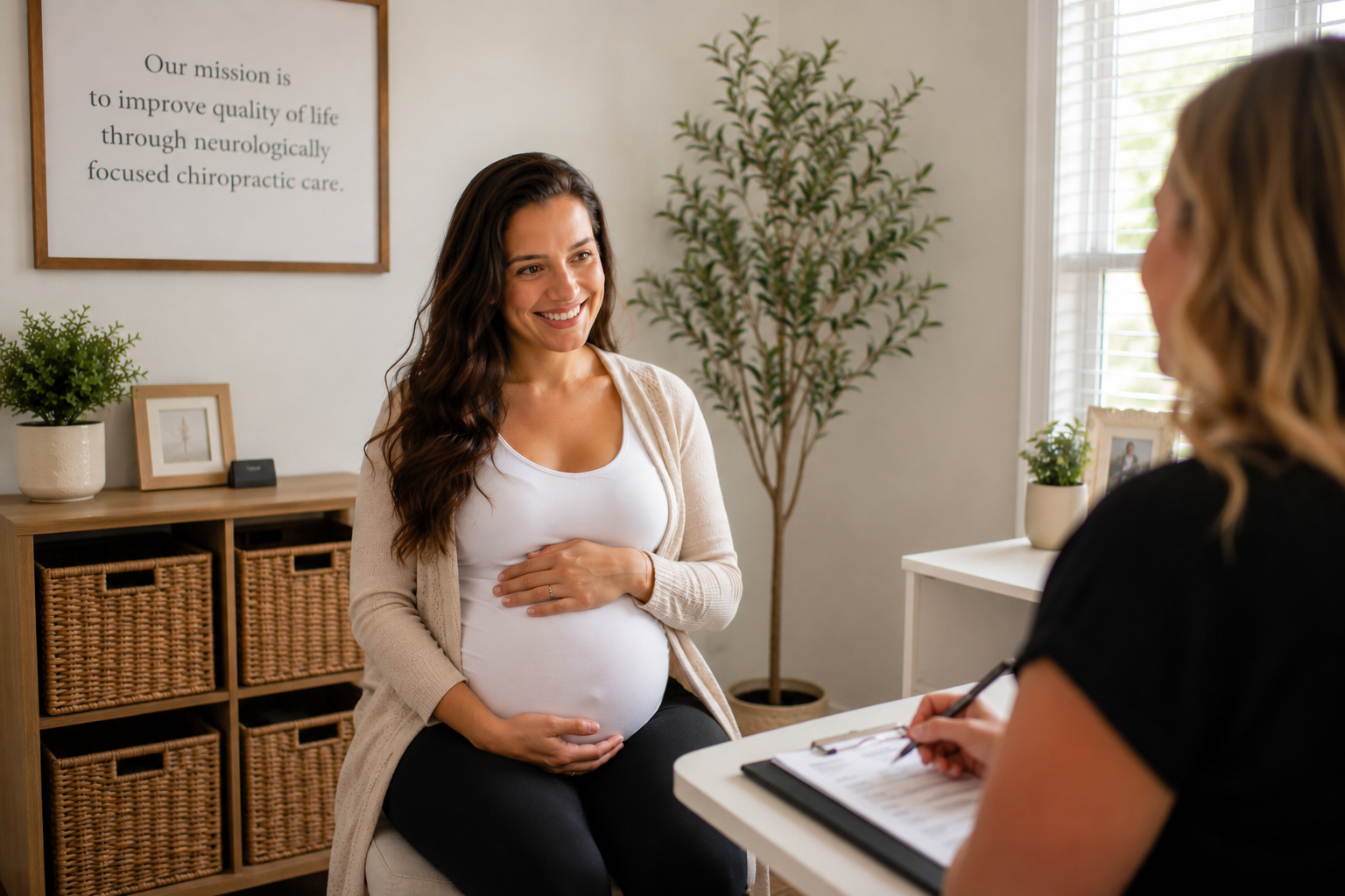 Pregnant woman discussing pregnancy discomfort with a Chiropractor at Precision Spine and Welness