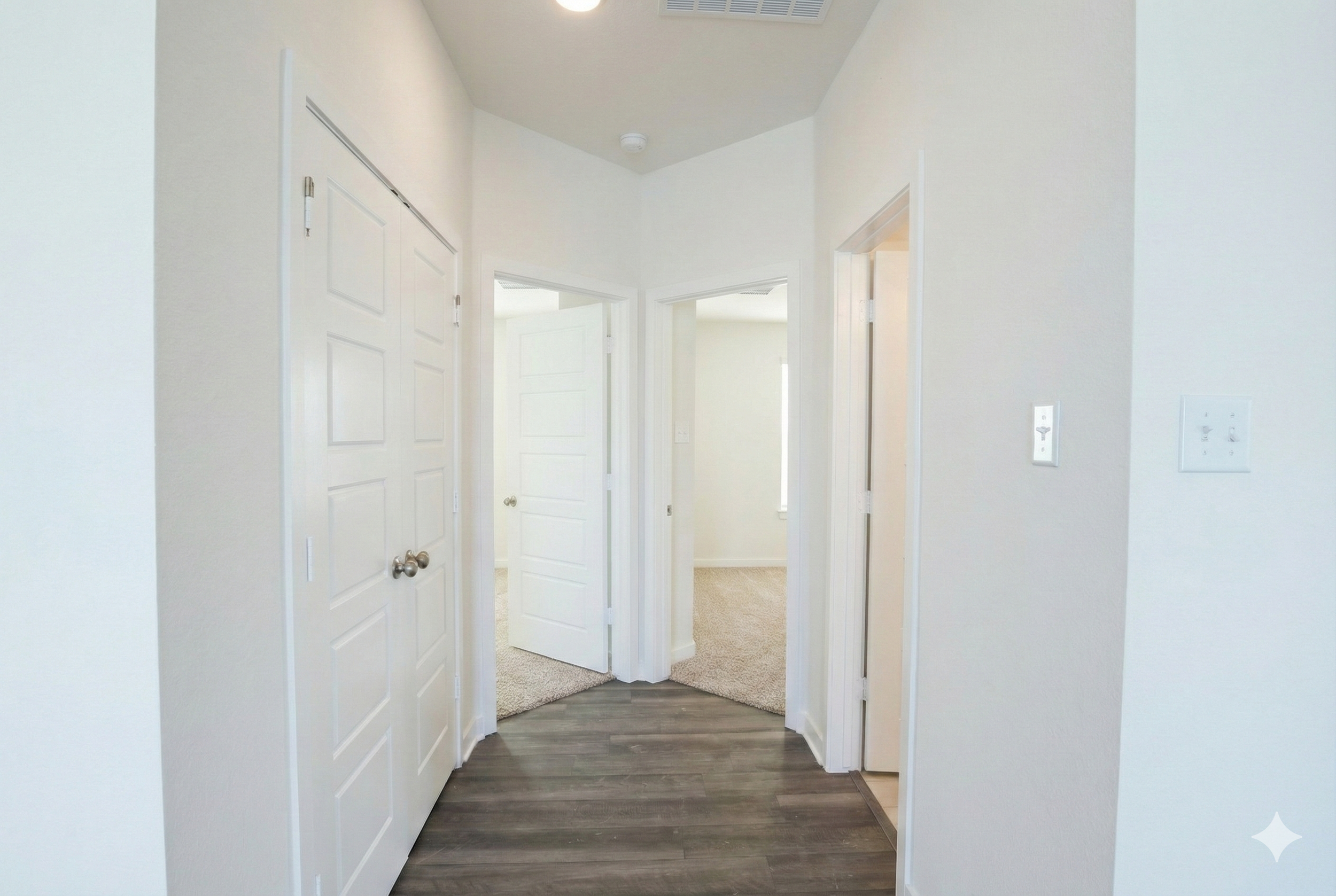Professional real estate photography of a vacant hallway connecting two bedrooms and a bathroom in a newly built 1,500 sq ft home. Serving Austin, Round Rock, Georgetown, Killeen, Temple, and Waco – Focus Point Media."