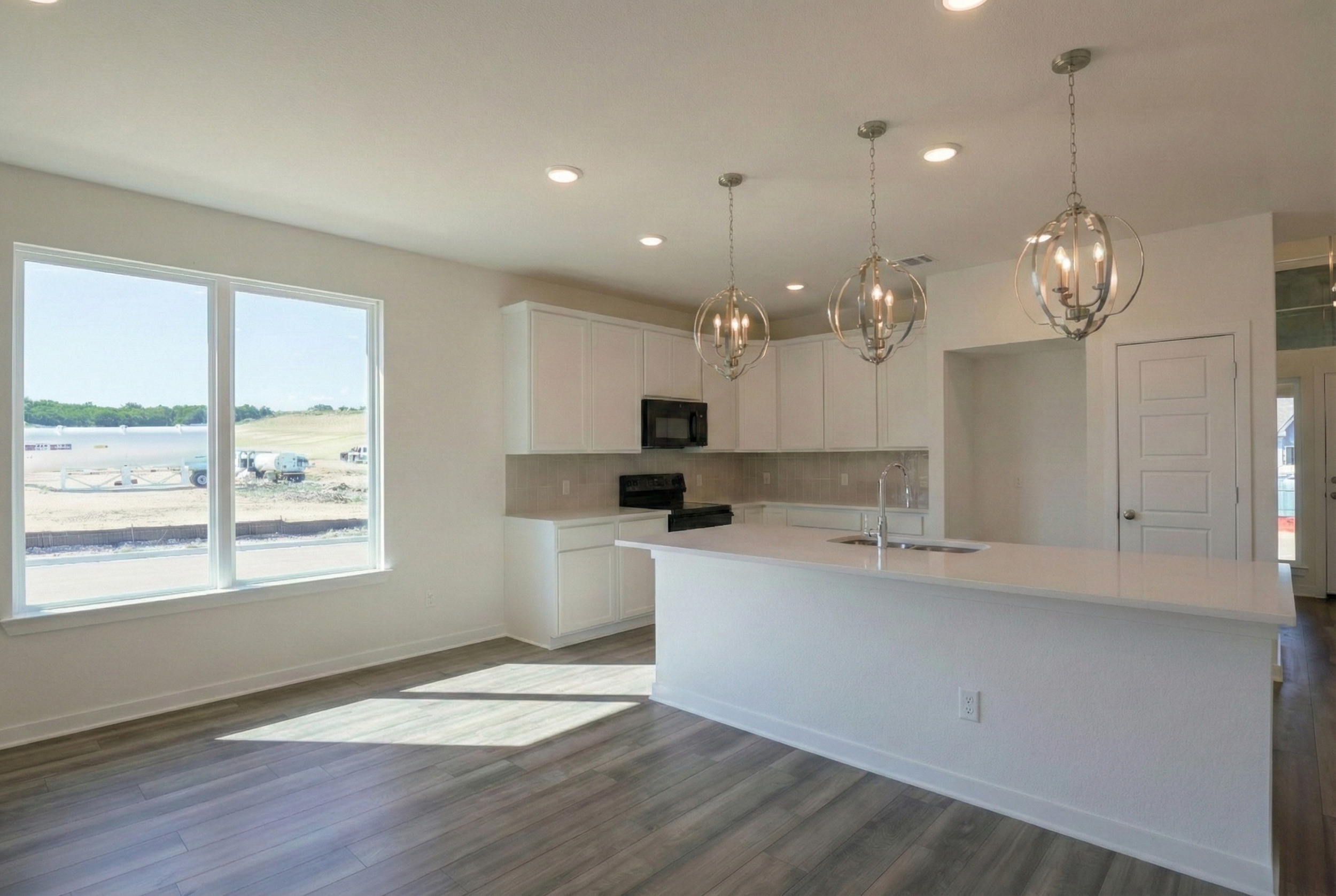 Professional real estate photography of a vacant, newly built kitchen in a 1,500 sq ft home. High-resolution interior shot for Central Texas listings in Austin, Round Rock, Georgetown, Killeen, Temple, and Waco - Focus Point Media.