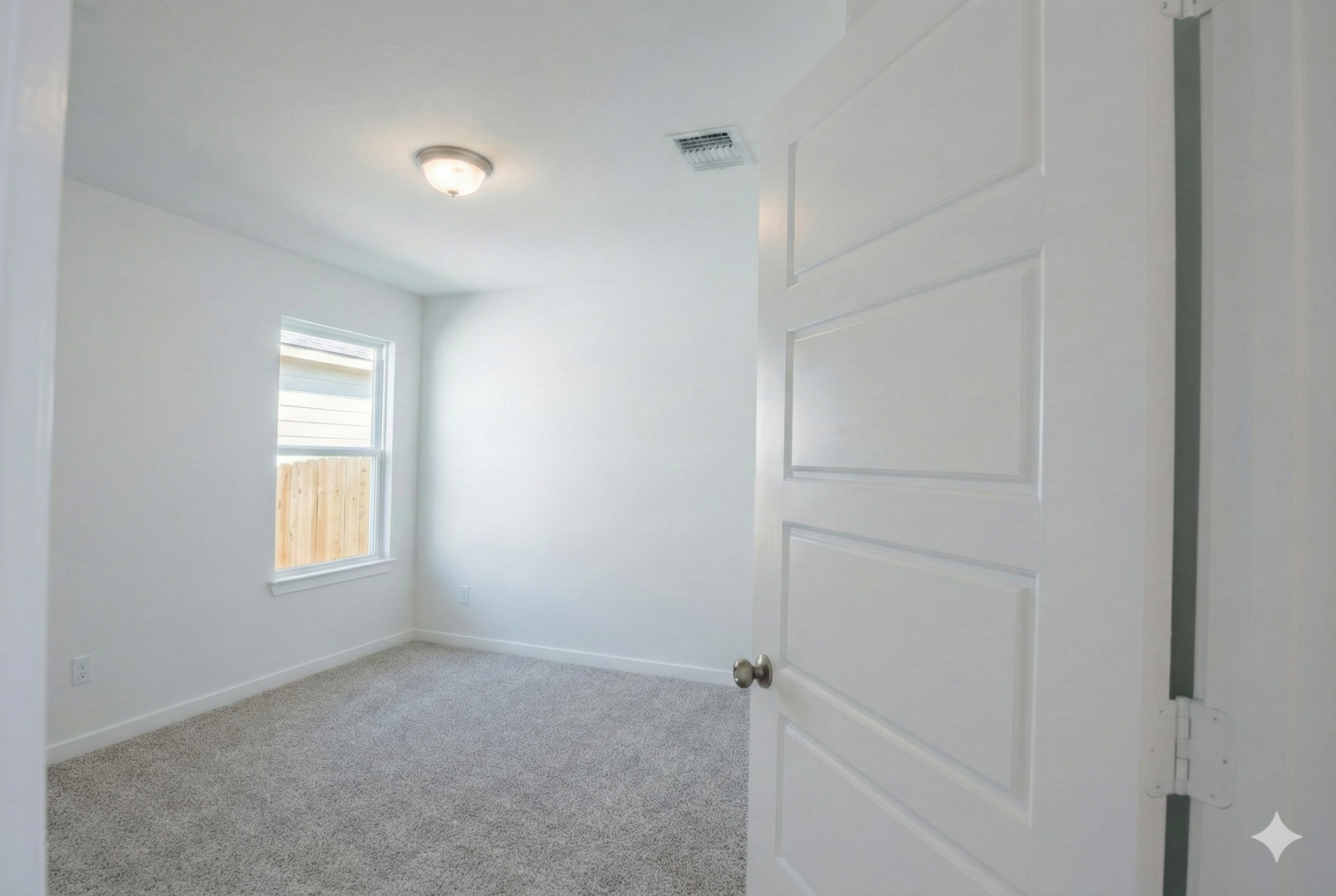 Professional real estate photography of a vacant bedroom in a newly built 1,500 sq ft home. Interior view from the doorway serving Central Texas listings in Austin, Round Rock, Georgetown, Killeen, Temple, and Waco - Focus Point Media.