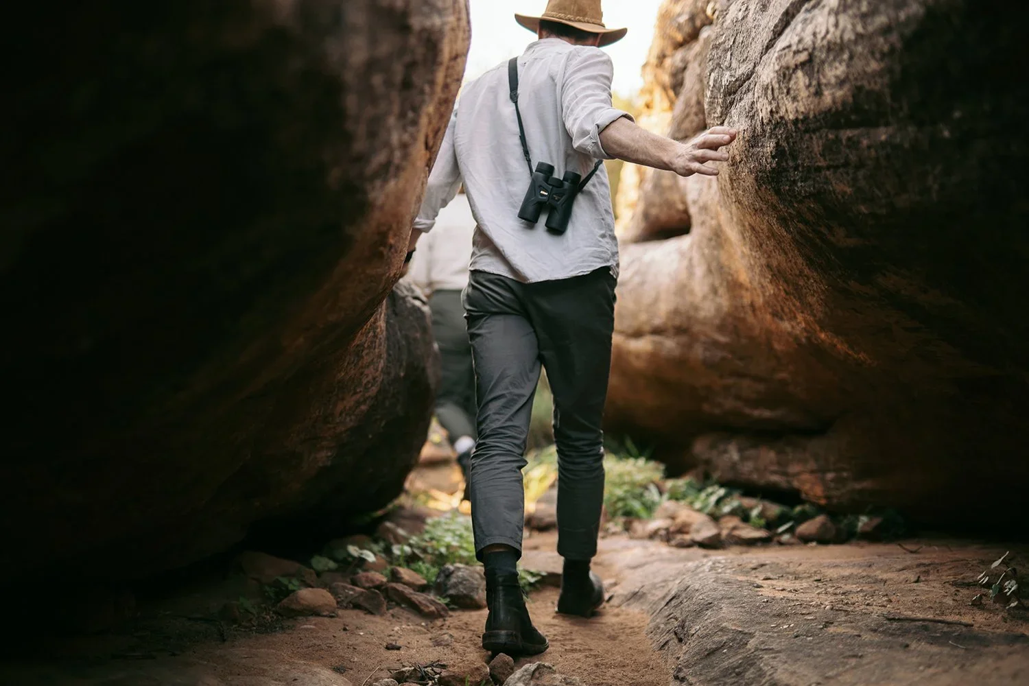 Person in canyon: Forensic guest experience audit exploring the physical touchpoints of a brand to ensure the digital promise matches the reality on the ground.