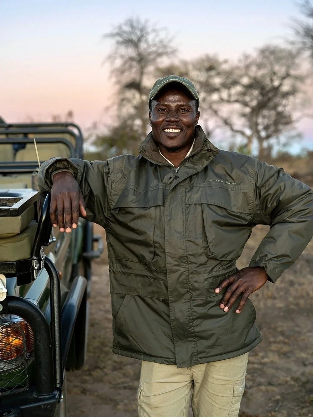 Guide by vehicle at dusk: Hospitality auditor Alex Hayn on-site at a private reserve, providing radical candor and strategic alignment for legacy safari brands.