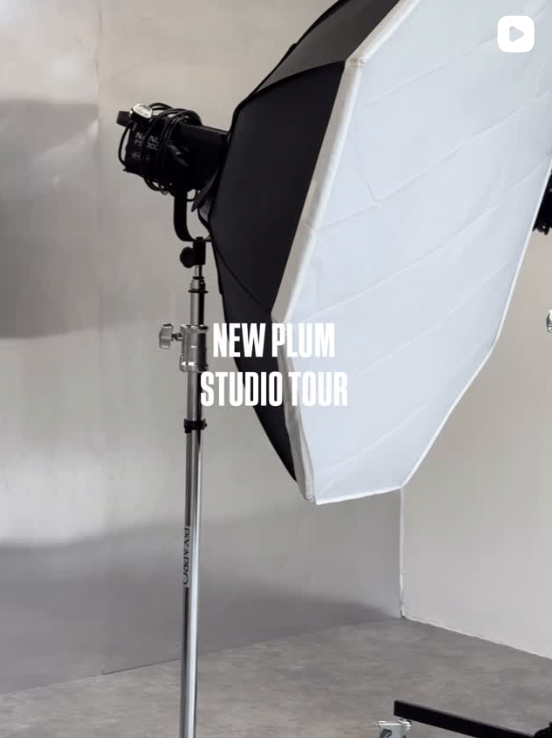 Photography studio with a large umbrella light and a backdrop, promoting the New Plum Studio Tour.
